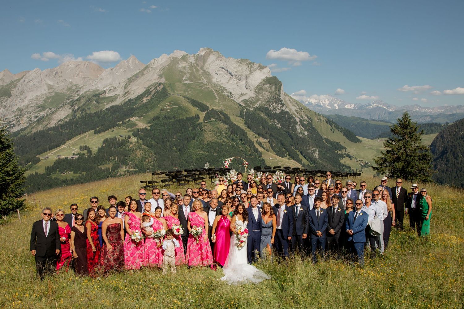 Morzine Wedding Photographer captures fun confetti photo at La Clusaz Wedding venue. French Mountain Wedding photographer. Outdoor Bride
