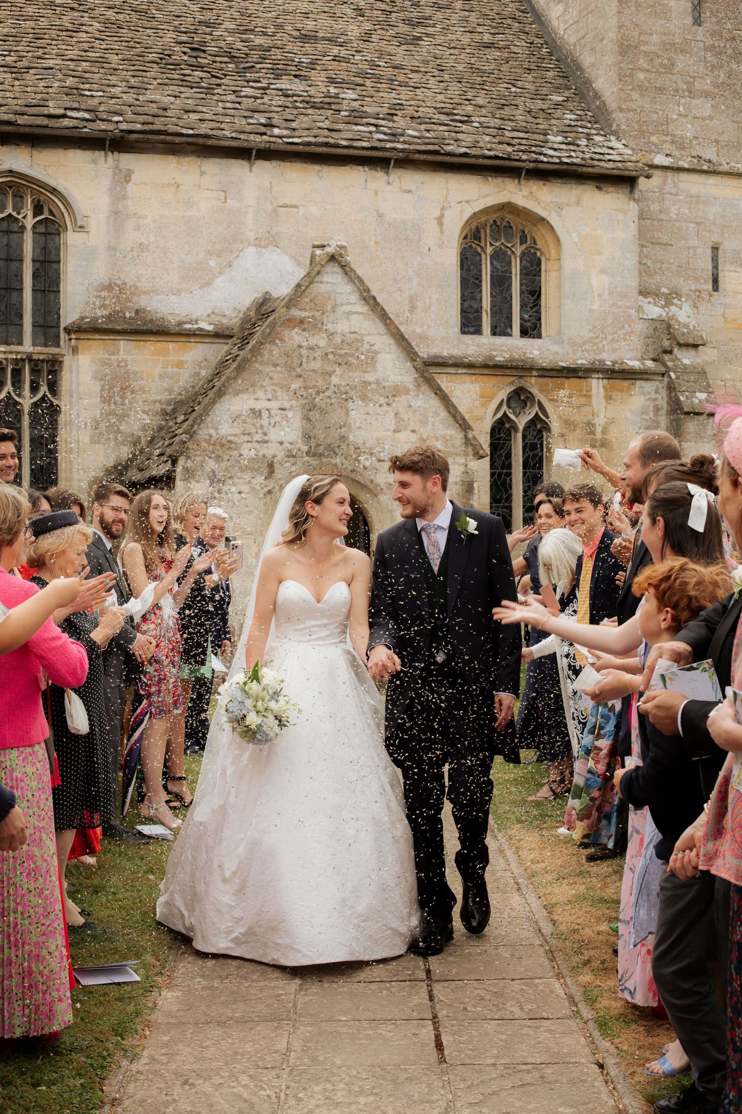 Documentary Style Cotswold Wedding Photographer captures wedding confetti at Gloucestershire Wedding Venue.Natural,candid and timeless photo