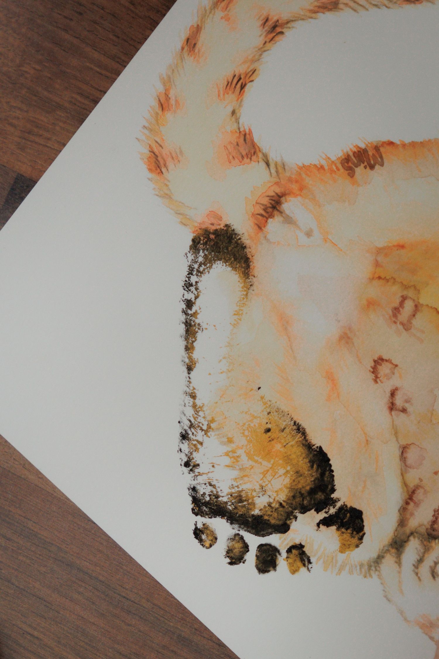 Watercolor painting of a bear created using footprints and handprints in orange and brown paint on white paper.