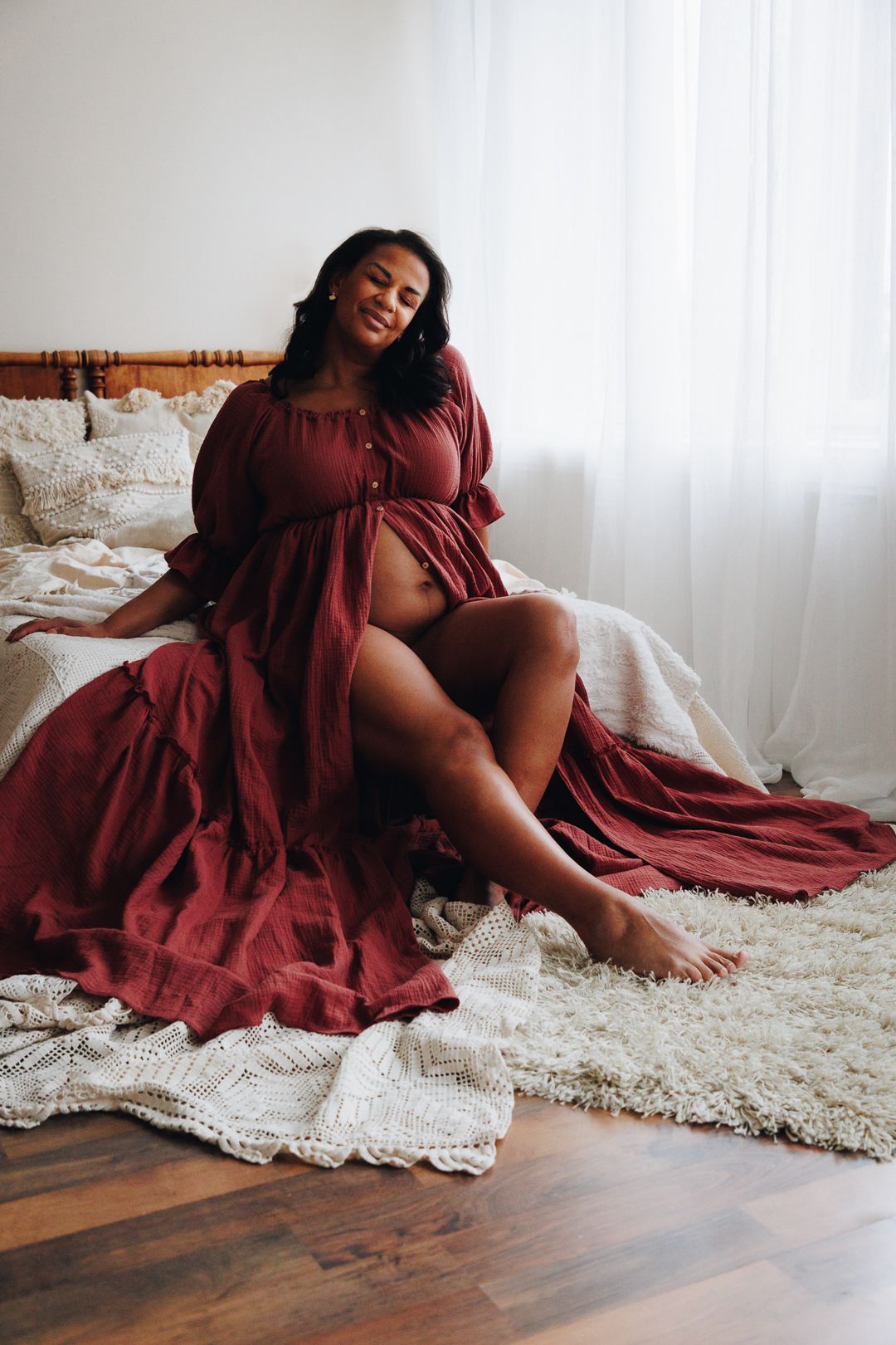 A series of artistic boudoir photos featuring a person in a burgundy dress posed elegantly on a cream-colored rug.