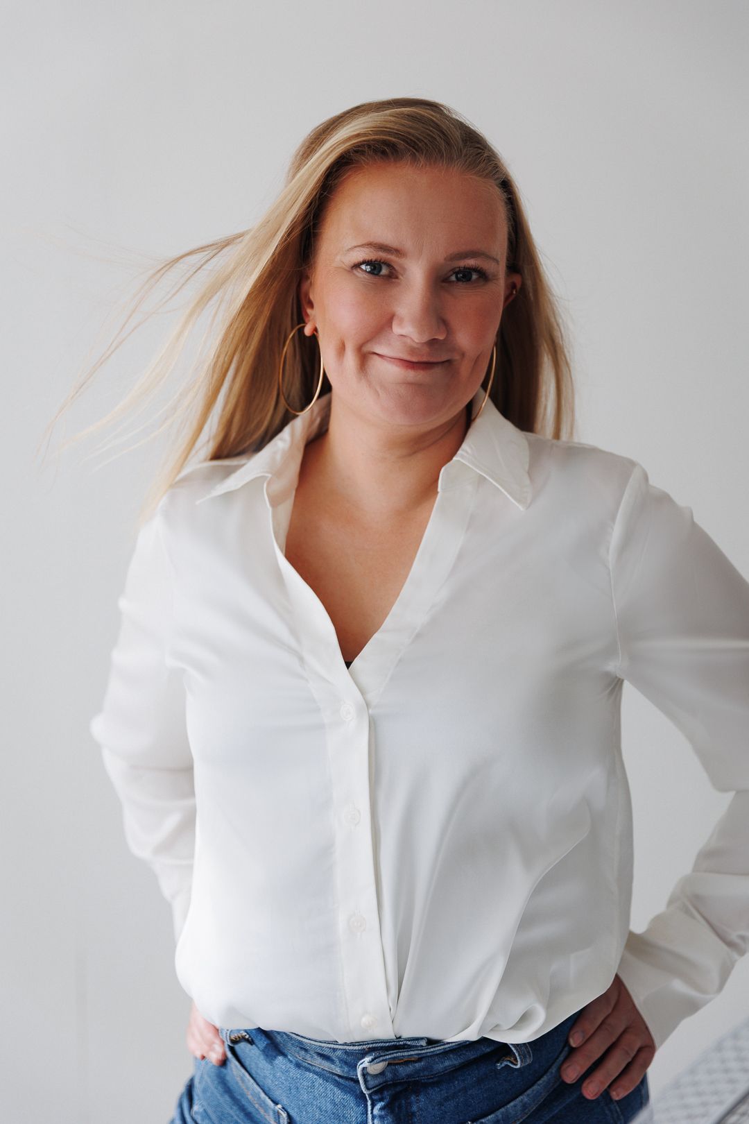 A series of photos showing someone in a crisp white button-down shirt and jeans against a light background.
