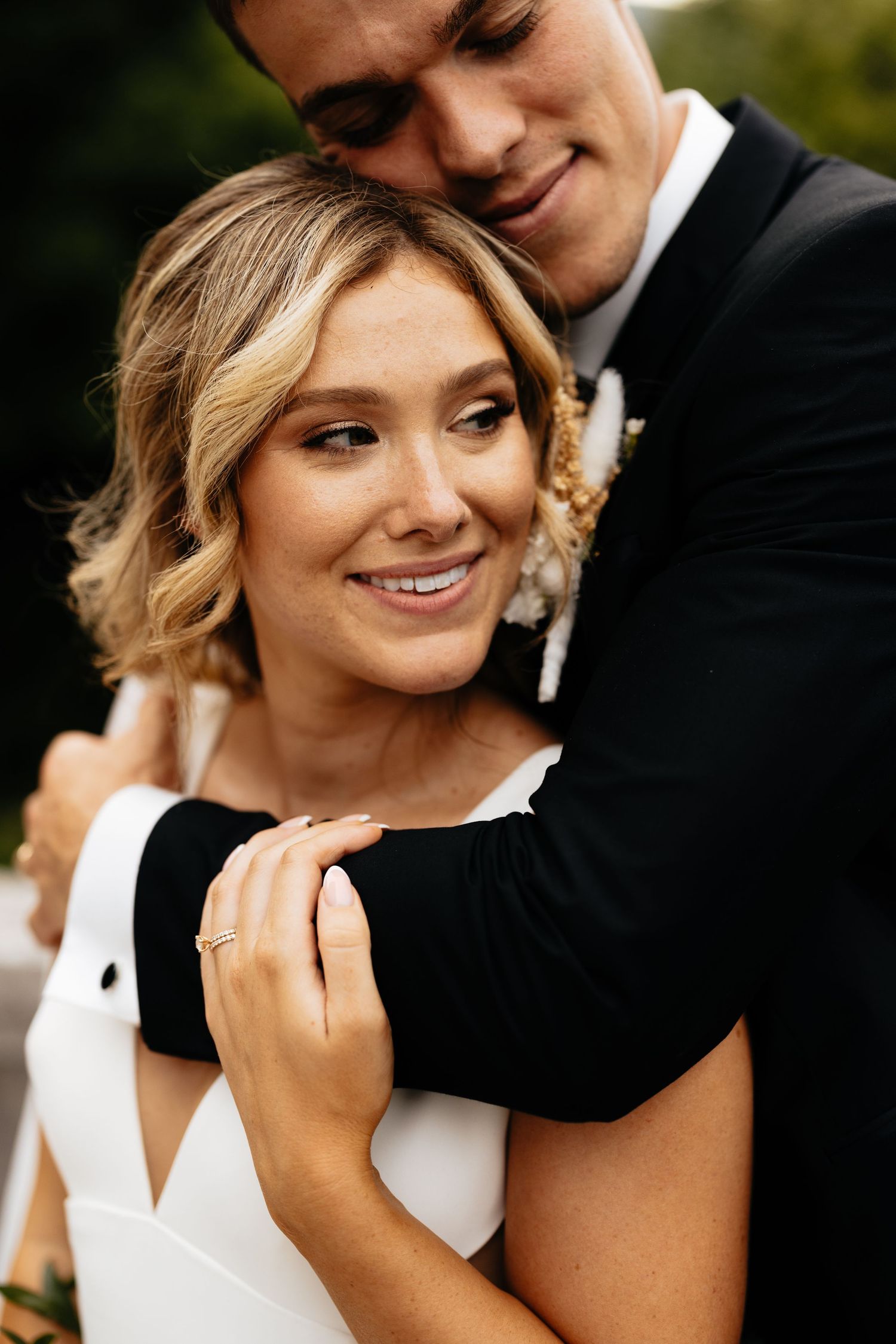 Close-up shots of newlyweds embracing during outdoor wedding celebration.