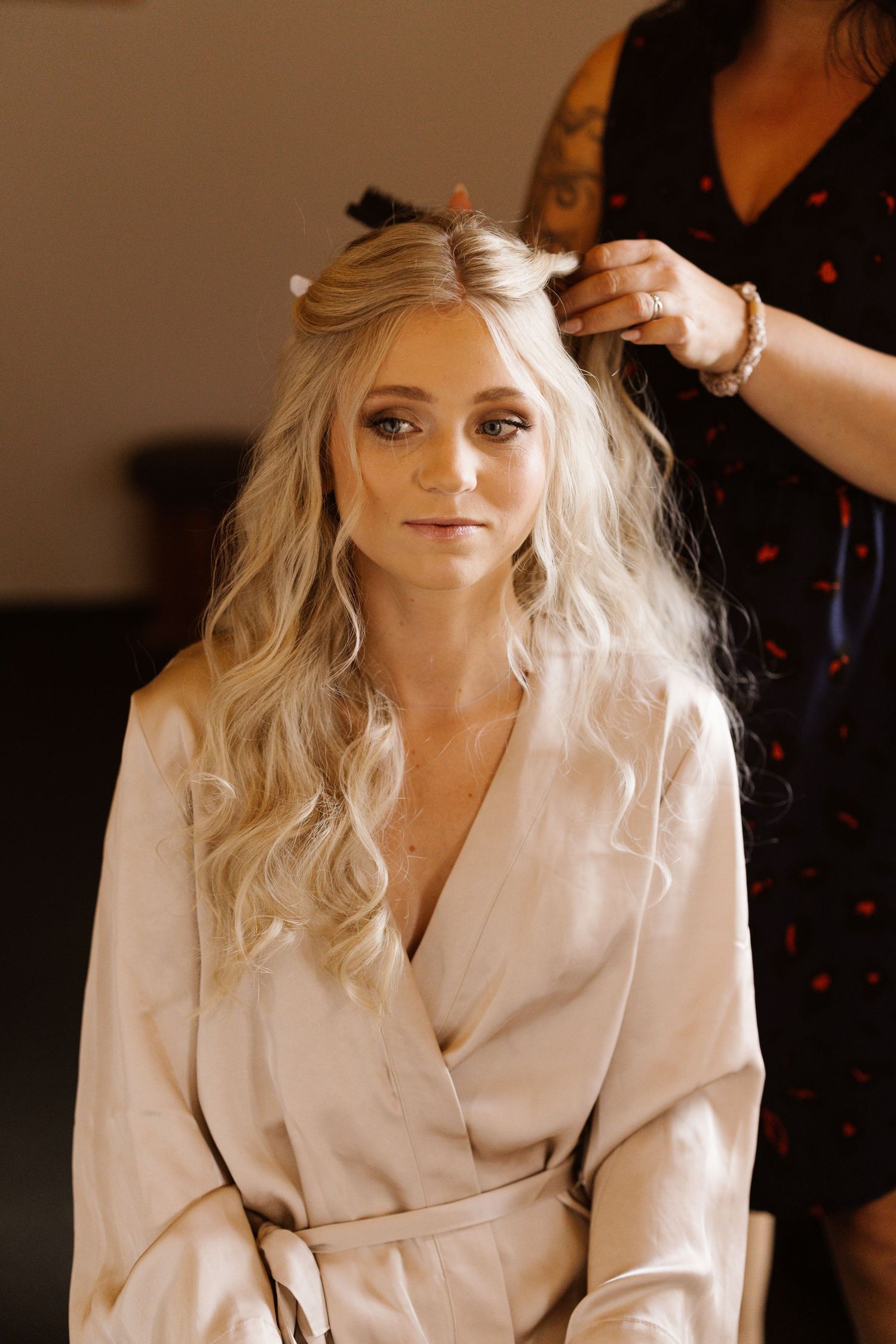 Wedding preparation photos showing a person in a white robe getting ready for the special day.