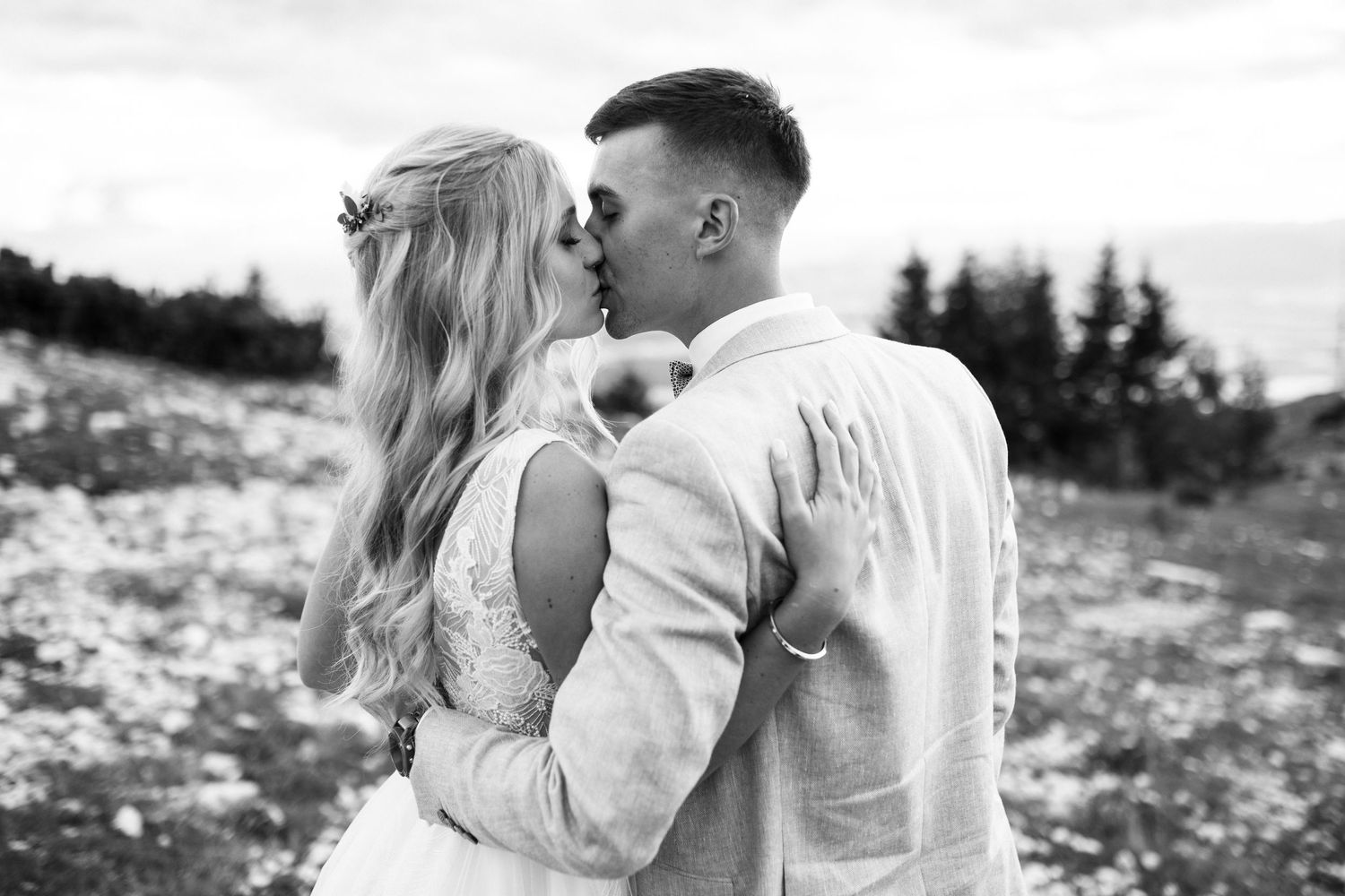Black and white photo collage showing a romantic couple kissing in various outdoor nature settings.