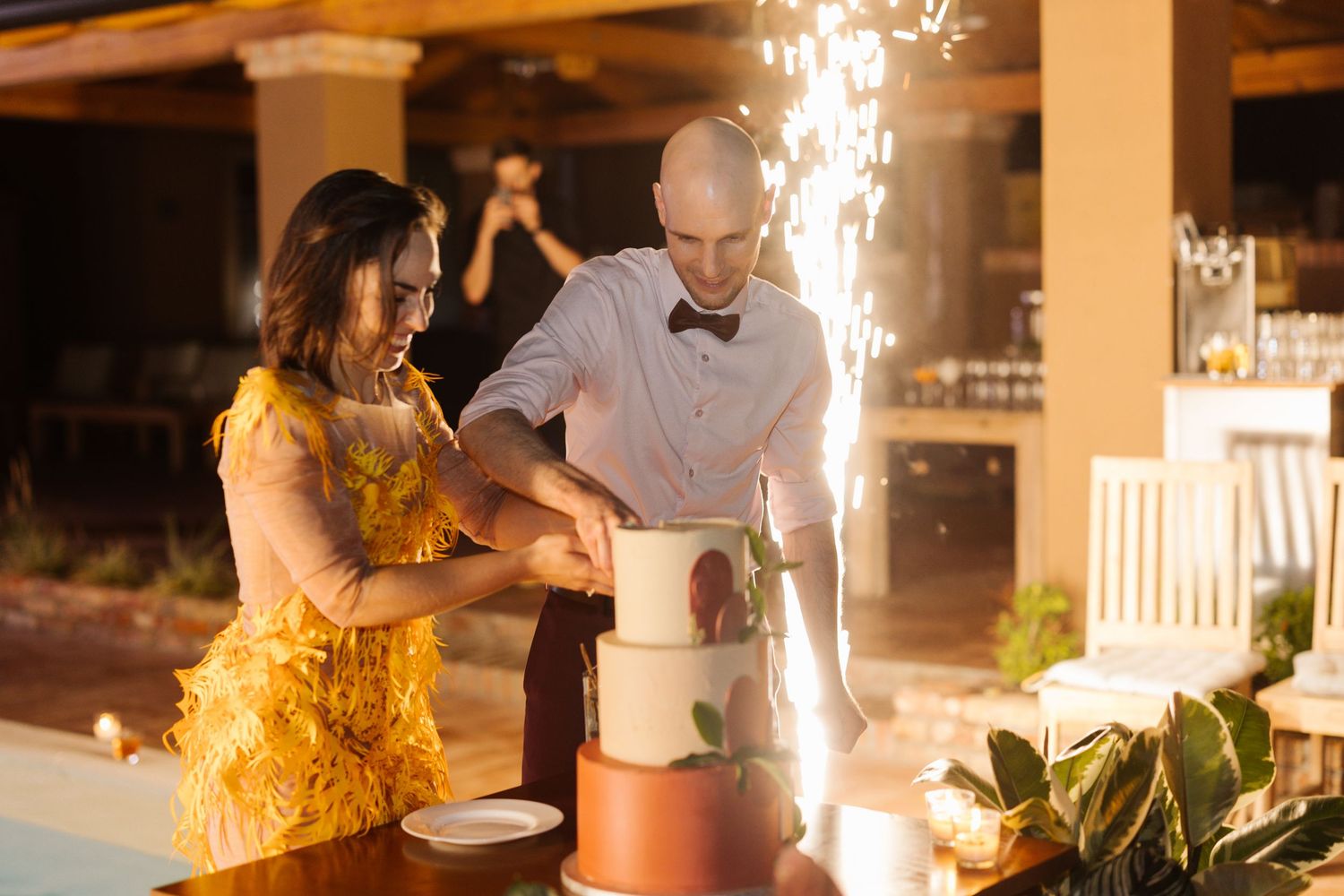 Wedding reception venue with sparklers and candlelight creating a romantic indoor atmosphere.