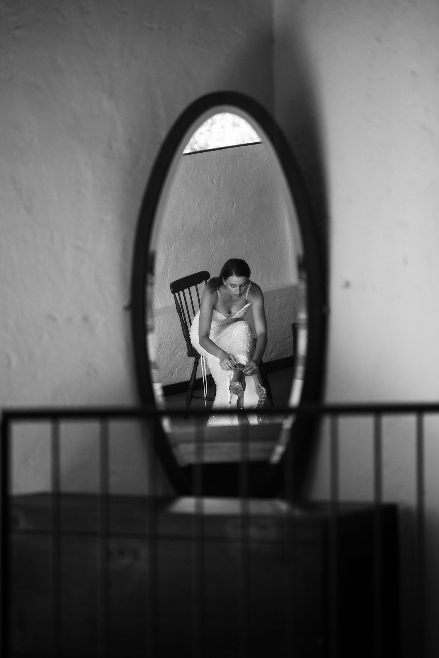 A series of black and white mirror reflections showing a figure in an arched frame creating a haunting sequence.