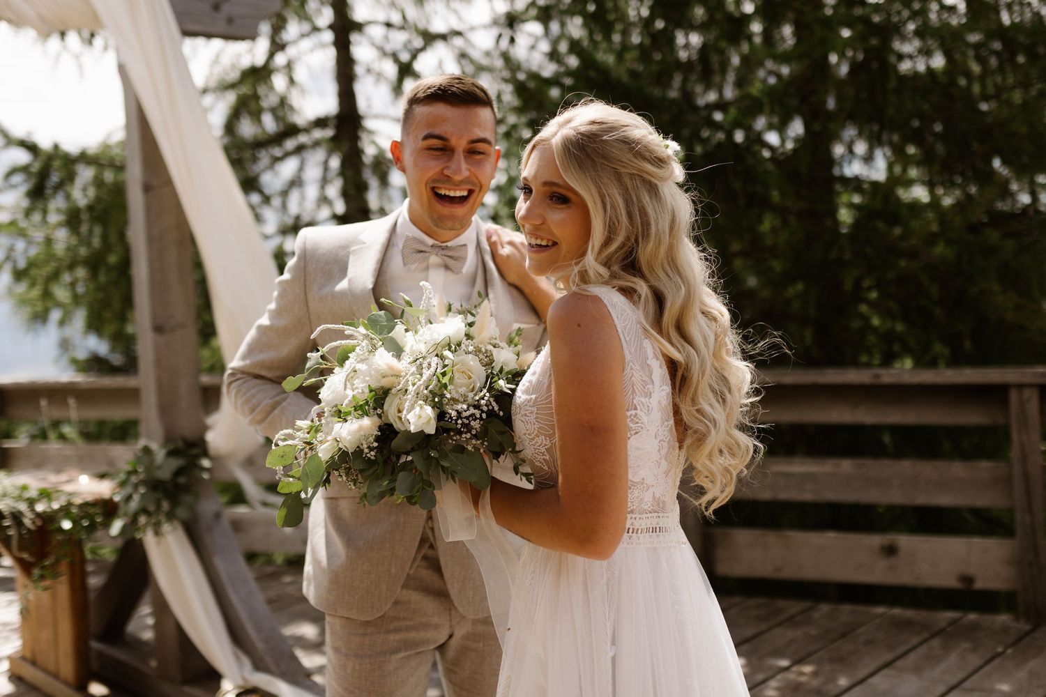 Bride and groom share an intimate moment during their rustic outdoor wedding ceremony.