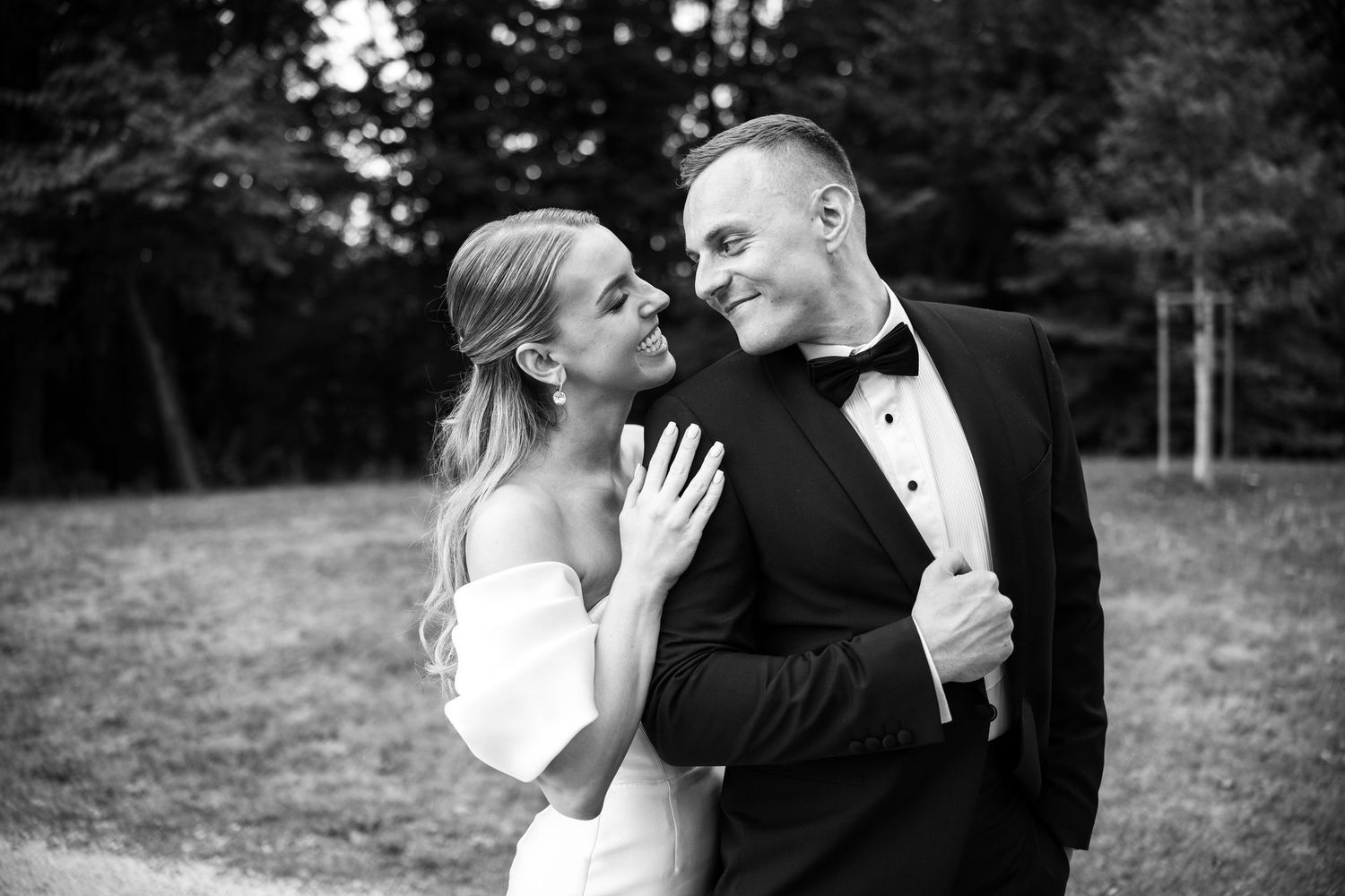 Romantic moments captured between newlyweds during outdoor photo session.