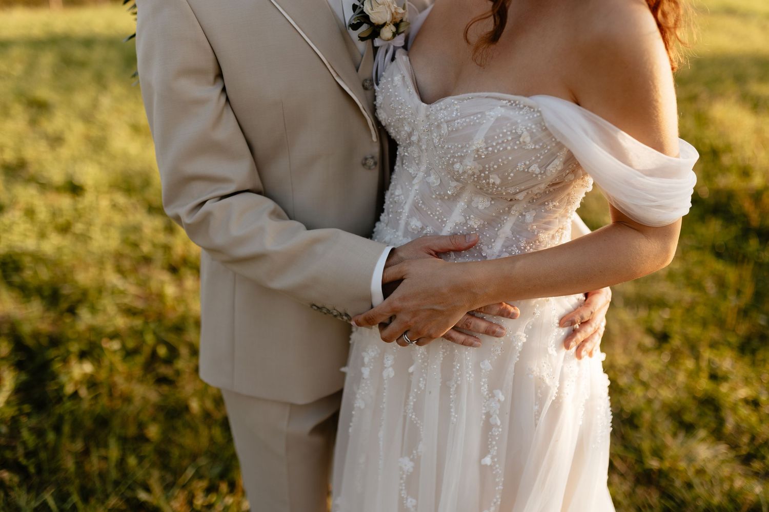 Golden hour wedding portraits showing romantic moments between newlyweds in a sunlit field.