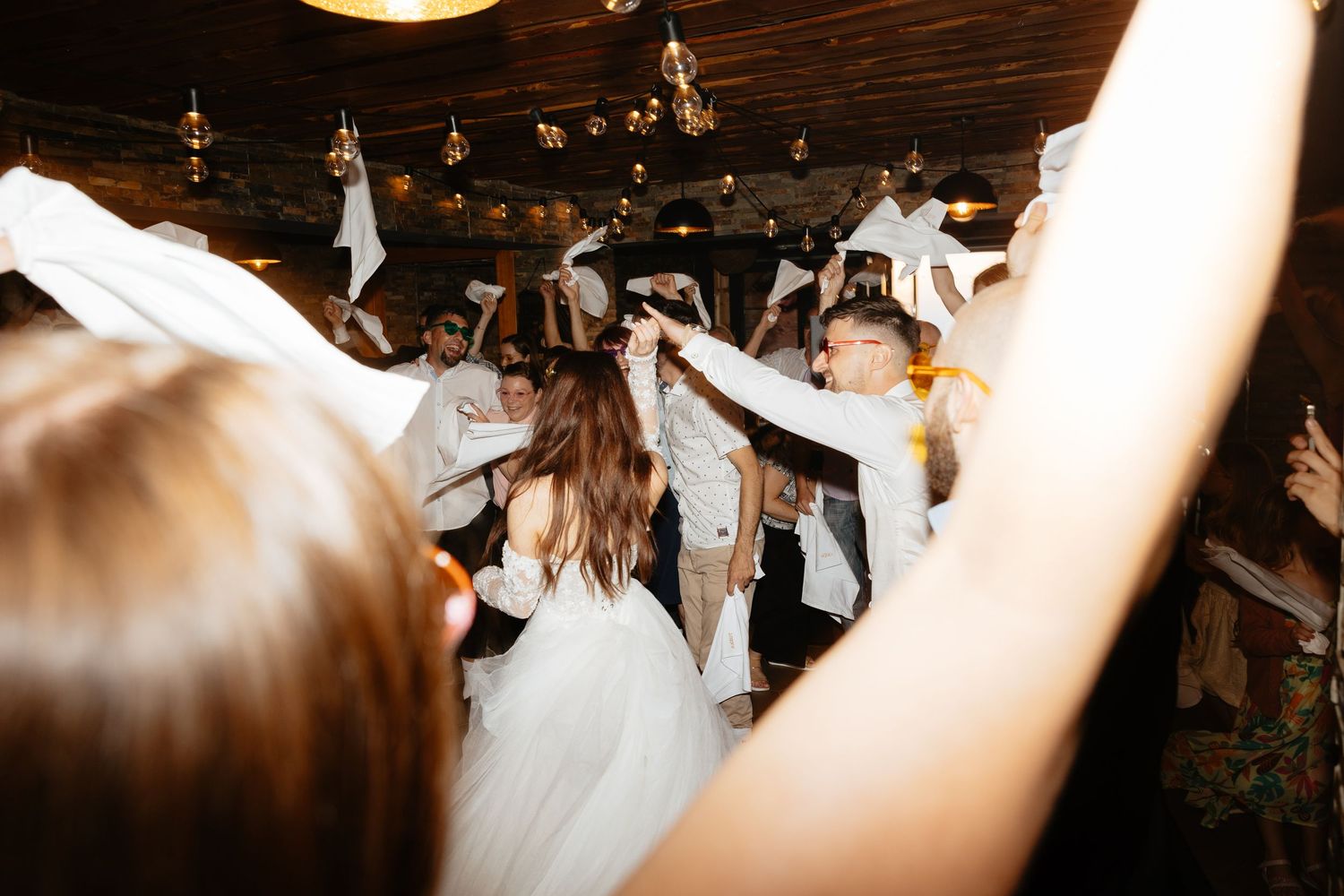 Atmospheric wedding reception scene with string lights creating a romantic ambiance.