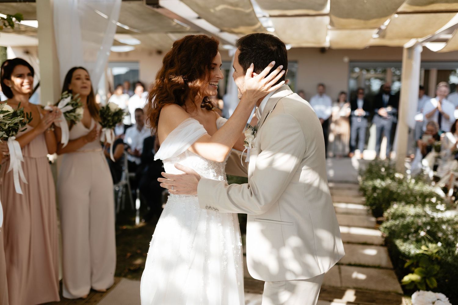 A collage of wedding moments showing couples dancing and embracing at an elegant indoor reception with white floral decor.