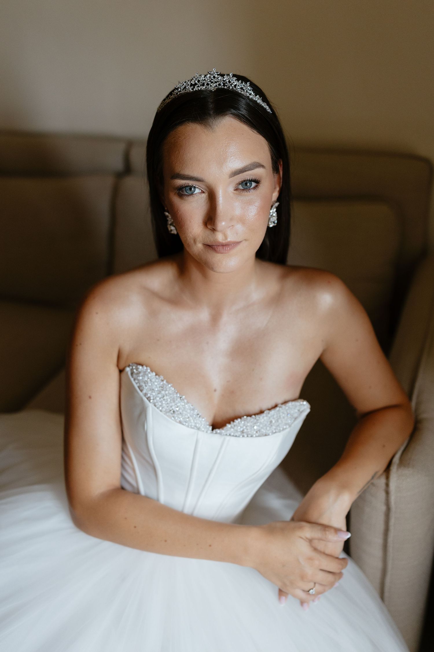 Close-up shots of a bride in a white corset dress wearing a sparkling tiara.