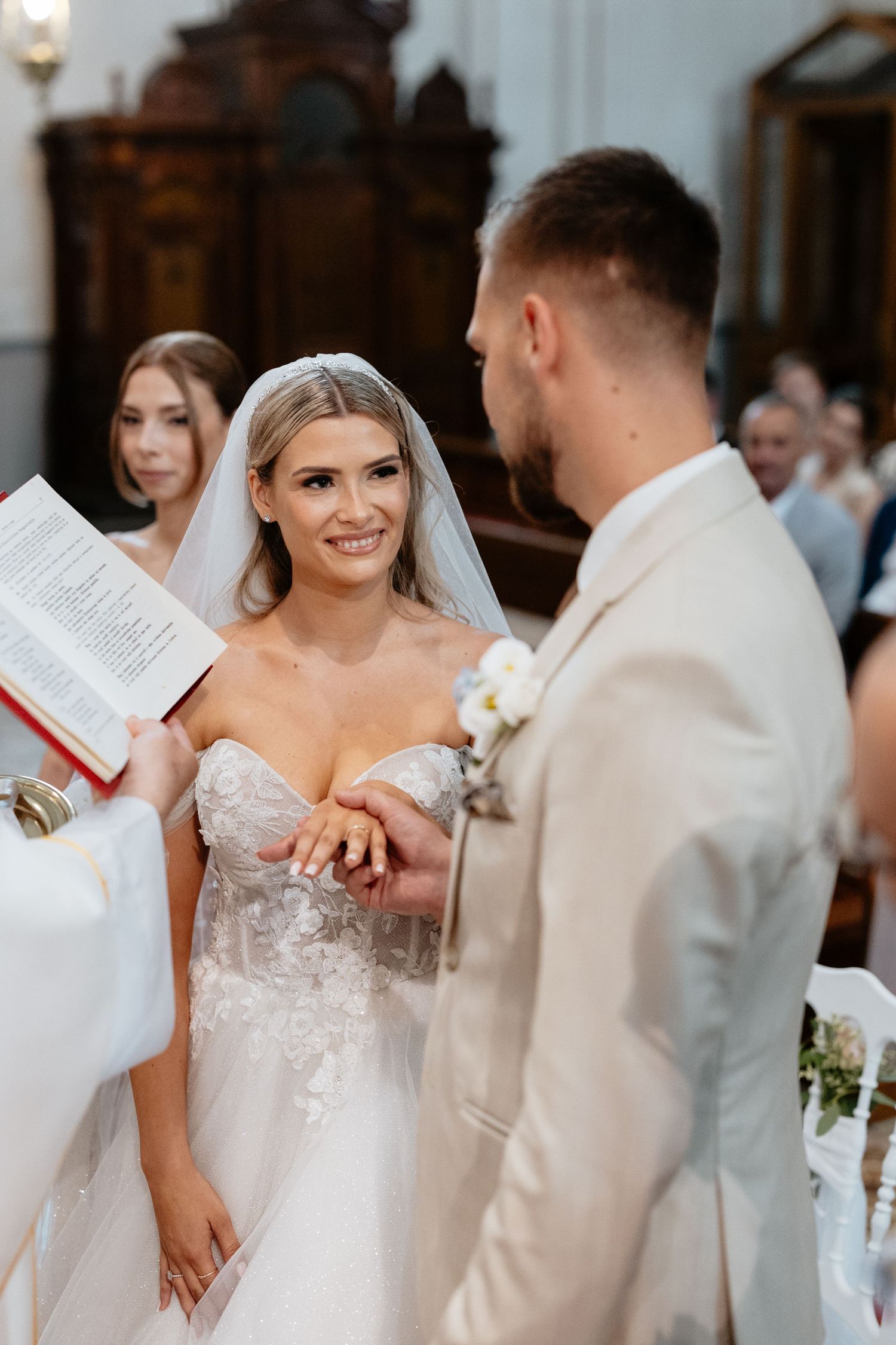 Wedding ceremony inside an elegant church with ornate tile floors and decorative details.