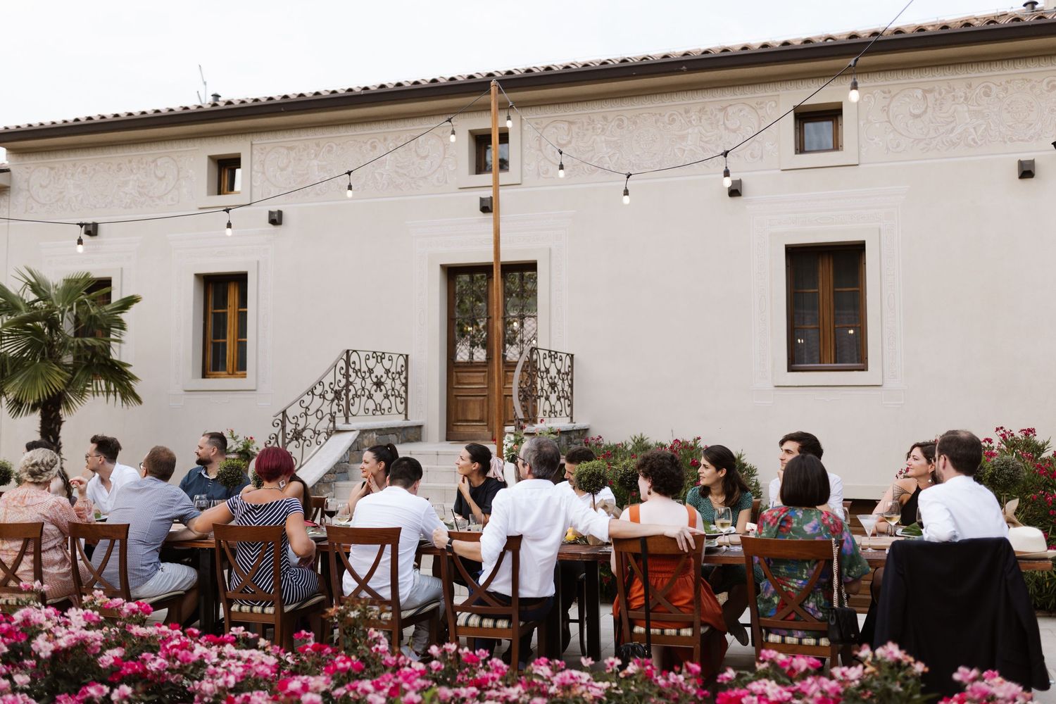 Wedding reception setup at a Mediterranean villa with white walls and pink floral decorations.