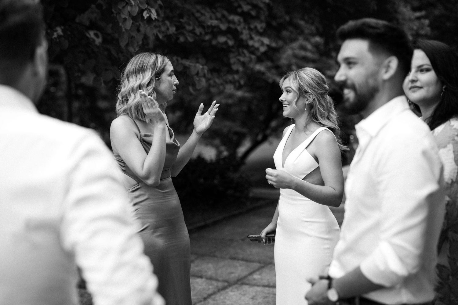Wedding guests dance and celebrate on an outdoor dance floor during a joyful reception celebration.