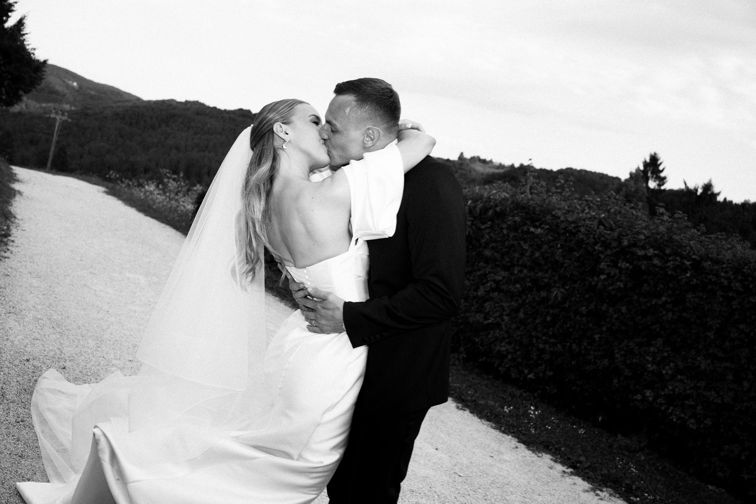 Black and white wedding portraits capturing intimate moments between newlyweds.