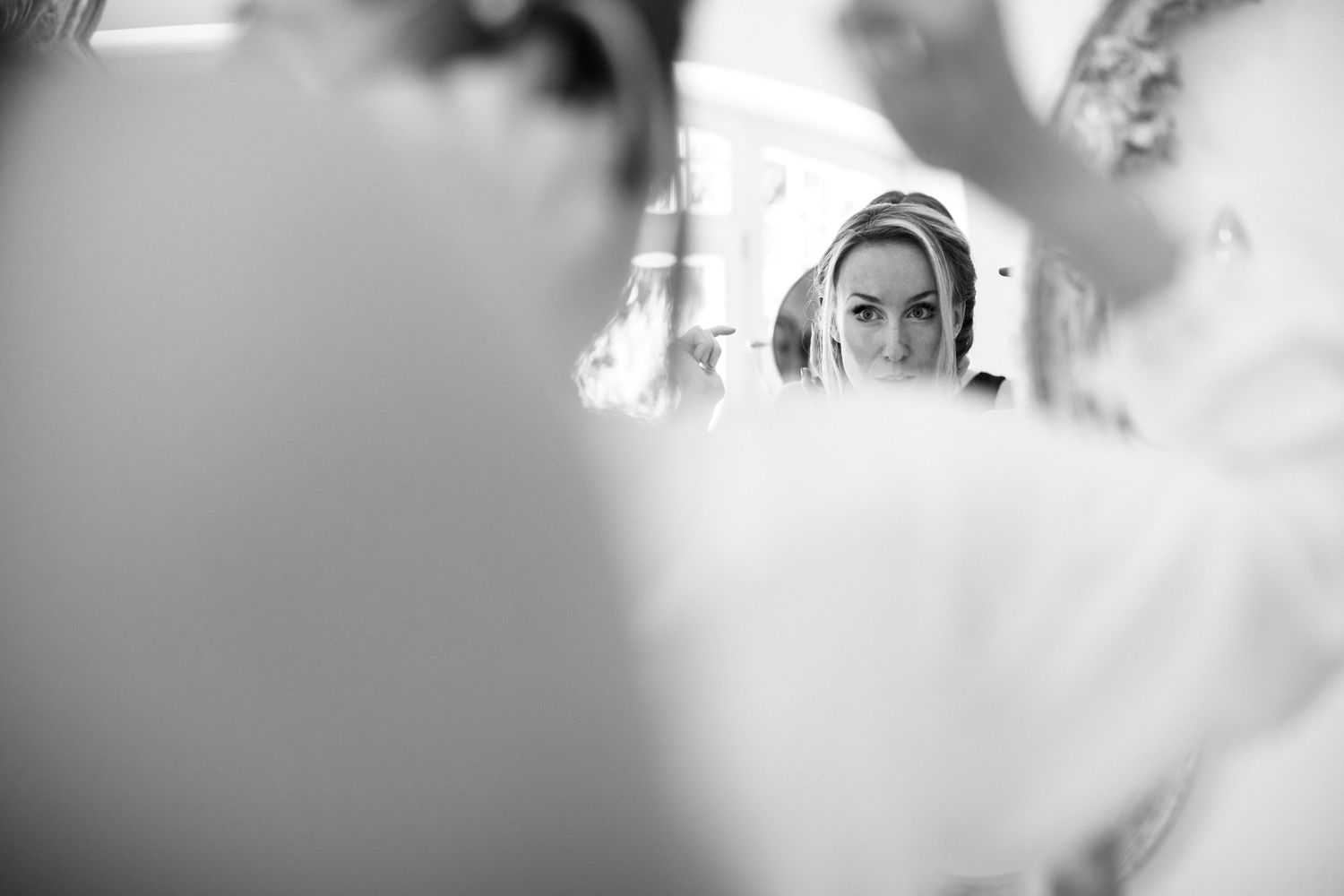 A black and white wedding photo series showing intimate moments between the couple during their special day.
