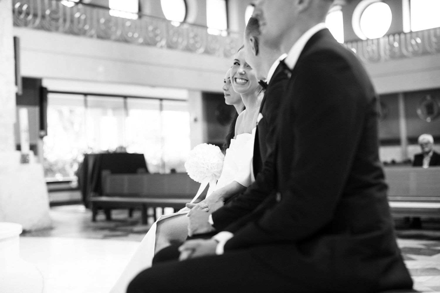 Black and white candid moment during church wedding ceremony.
