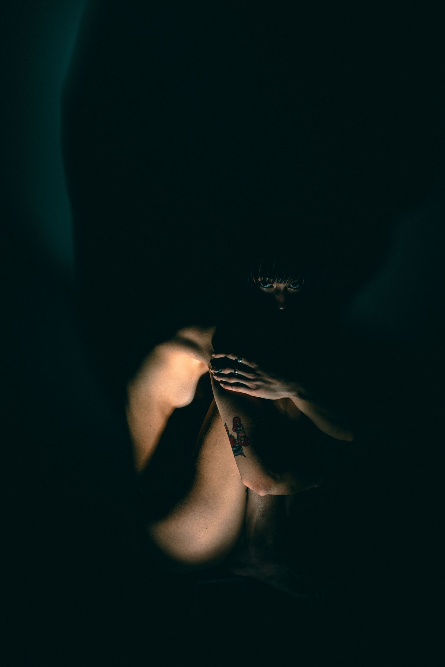 Abstract dark photography with soft circular light bokeh effects.