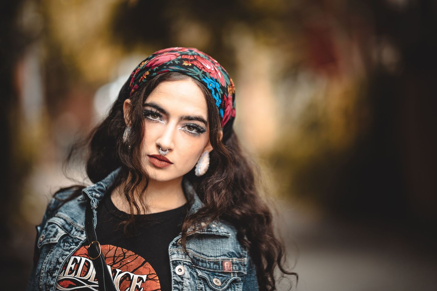 Alternative fashion portrait with denim jacket and colorful accessories.