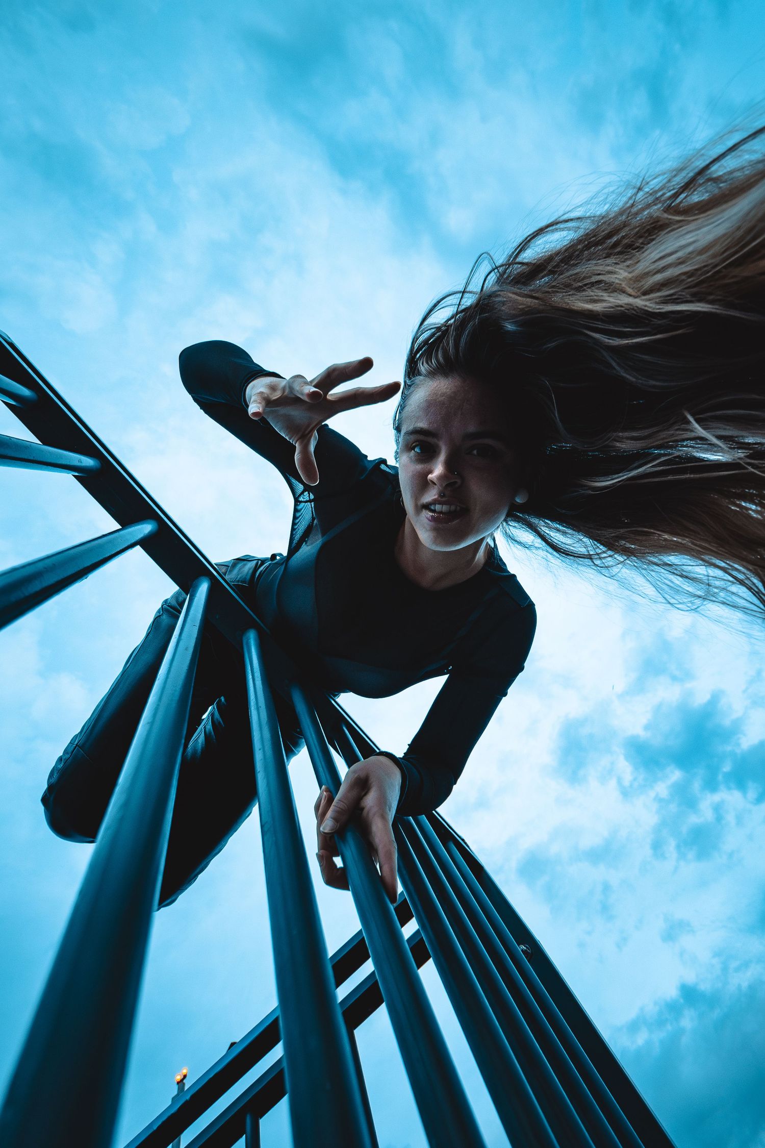 Dynamic low angle shots against blue sky showing artistic movement and dramatic poses.