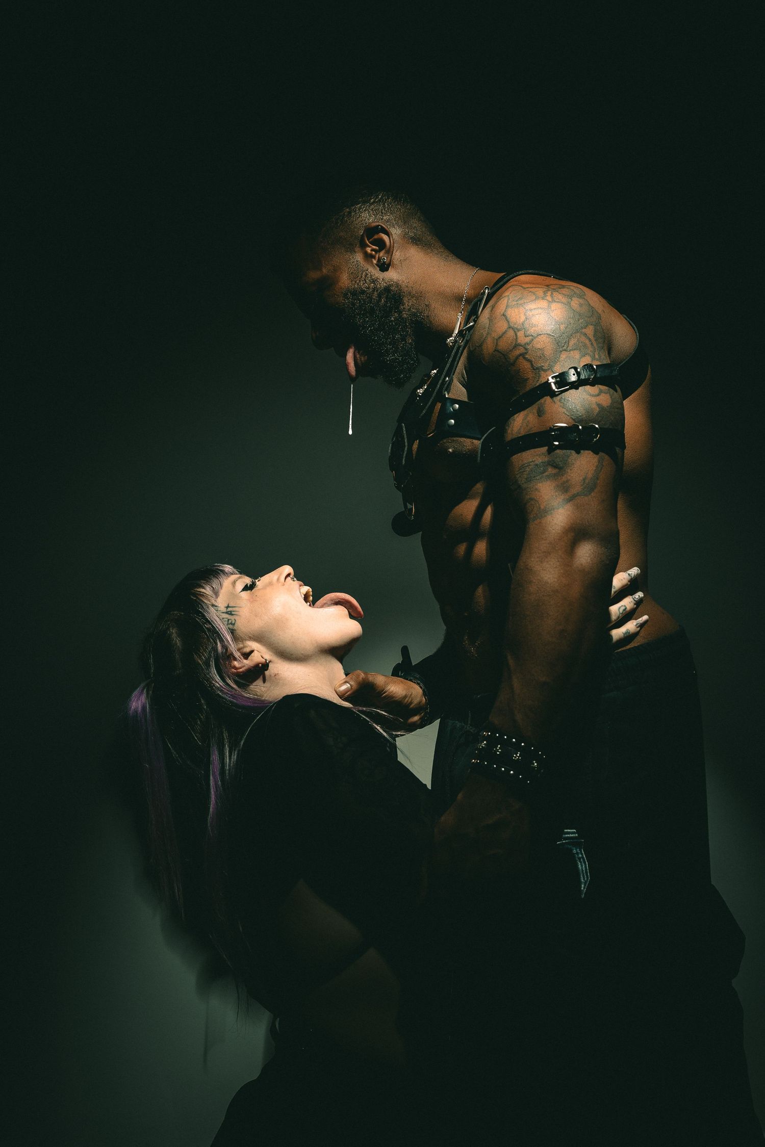 Dramatic low-key portrait sequence with leather accessories.
