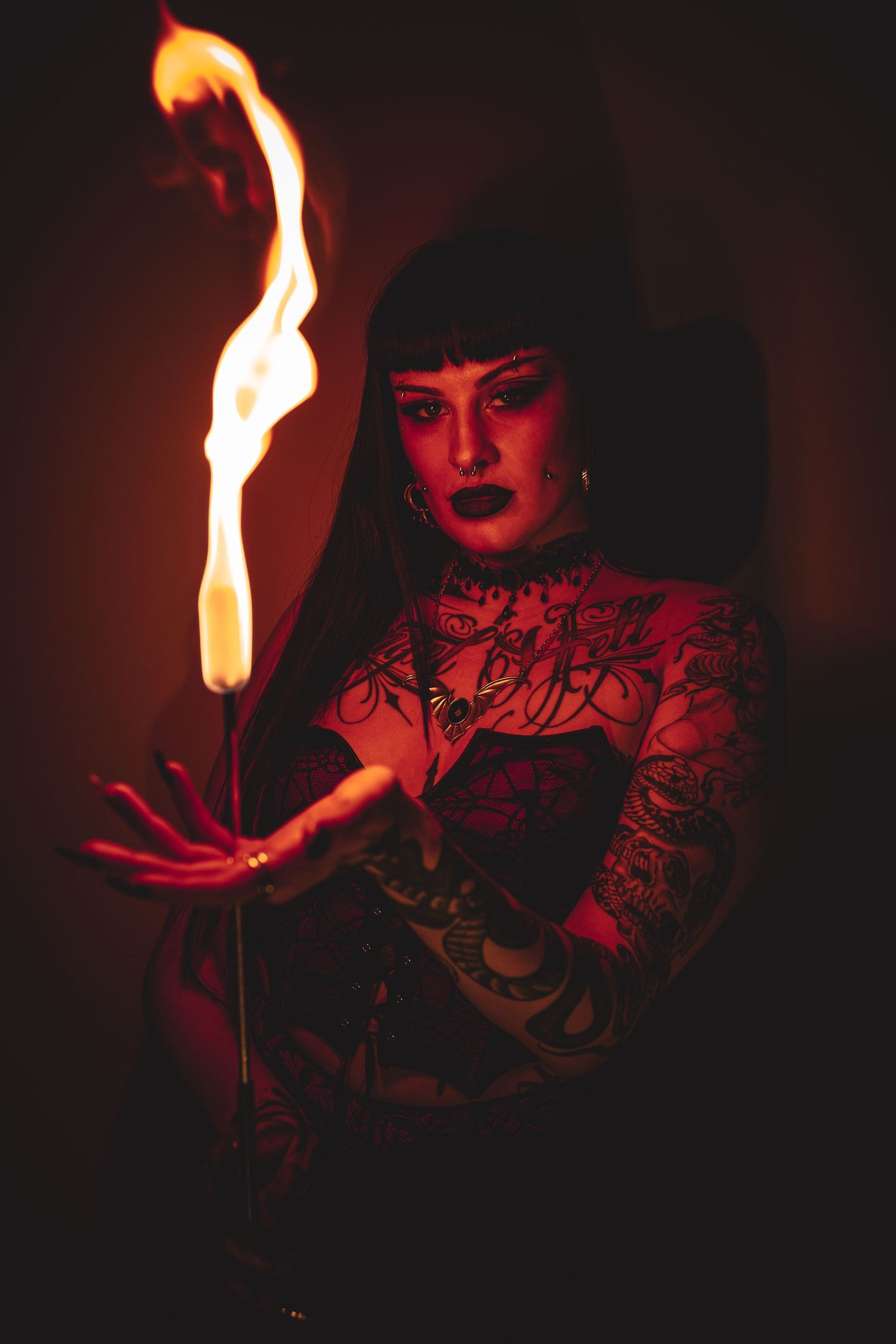 Dramatic portrait with fire illumination against dark background.
