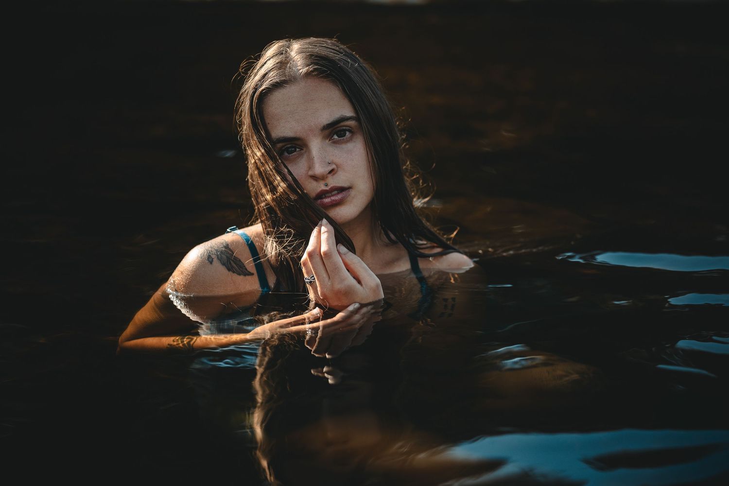 Dark and moody boudoir portraits with dramatic lighting effects.