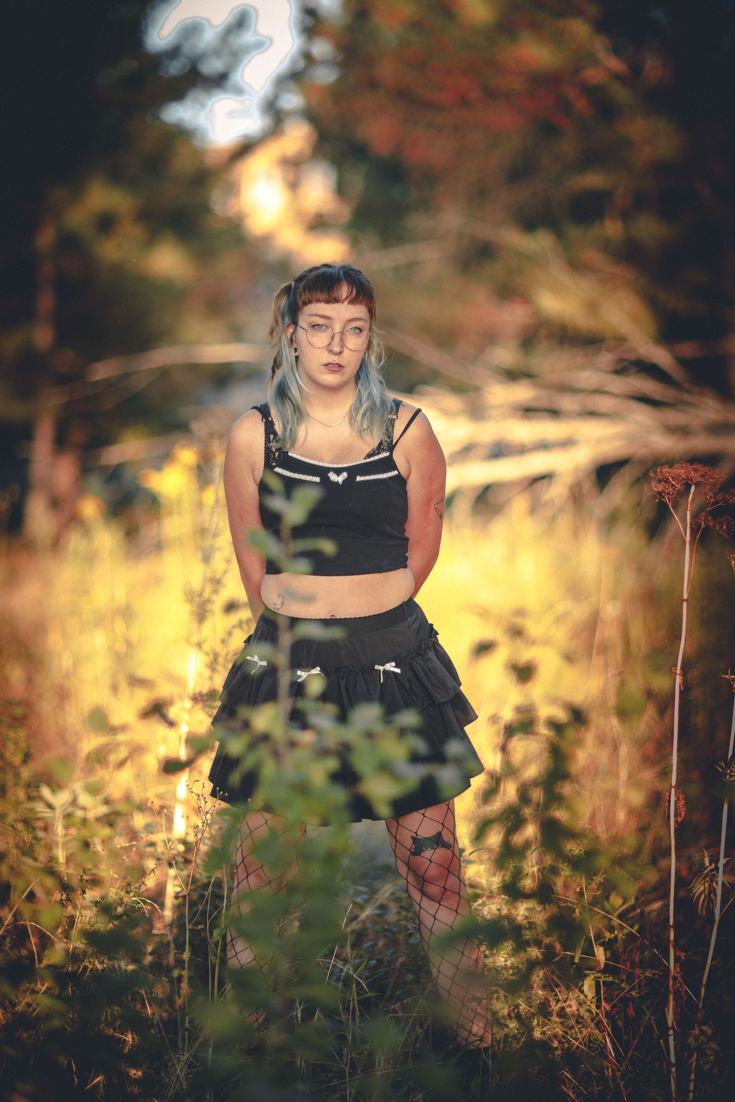 Artistic portrait series in golden field with tall grass and natural lighting.