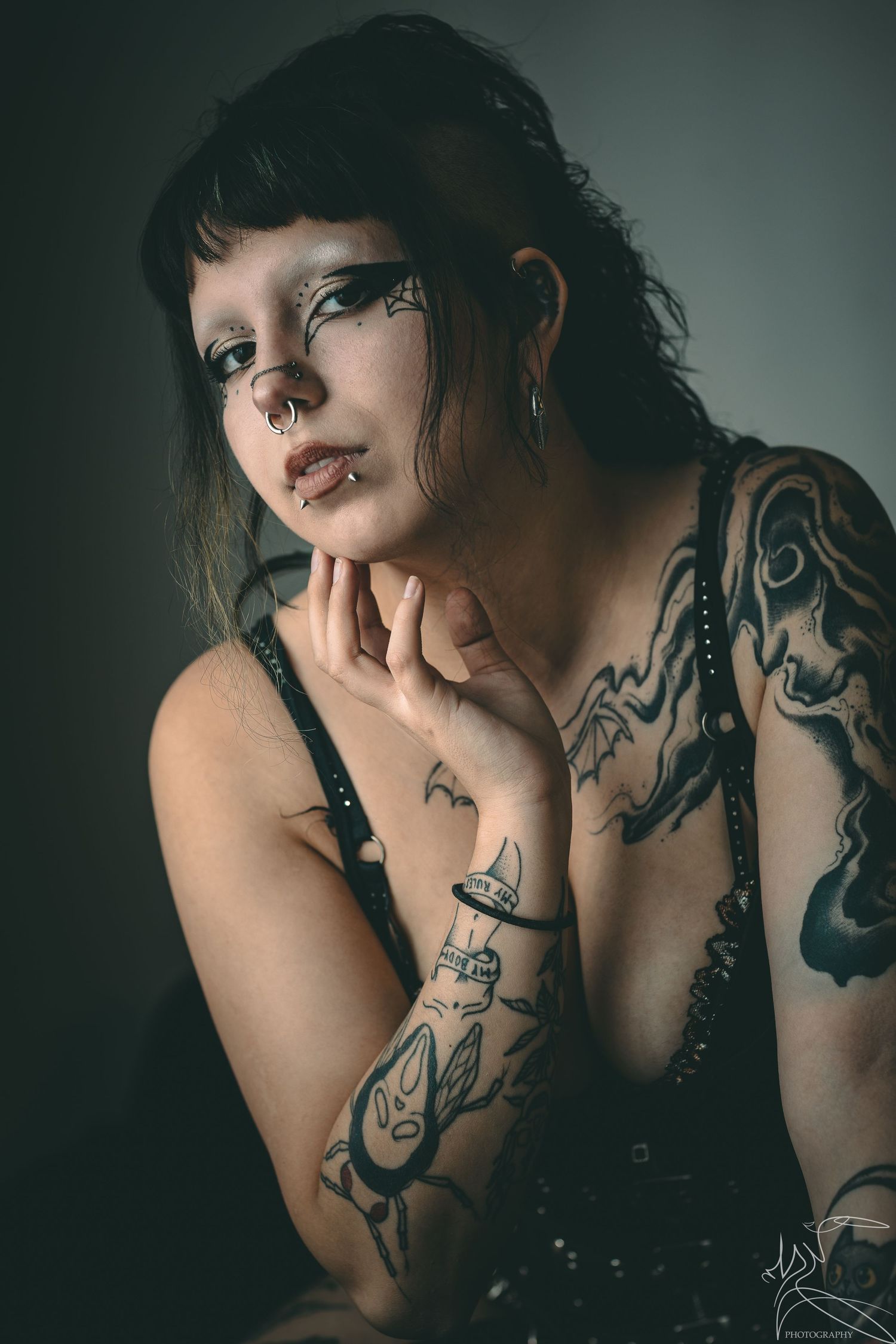 Artistic portrait series showing tattoo artwork in moody lighting.