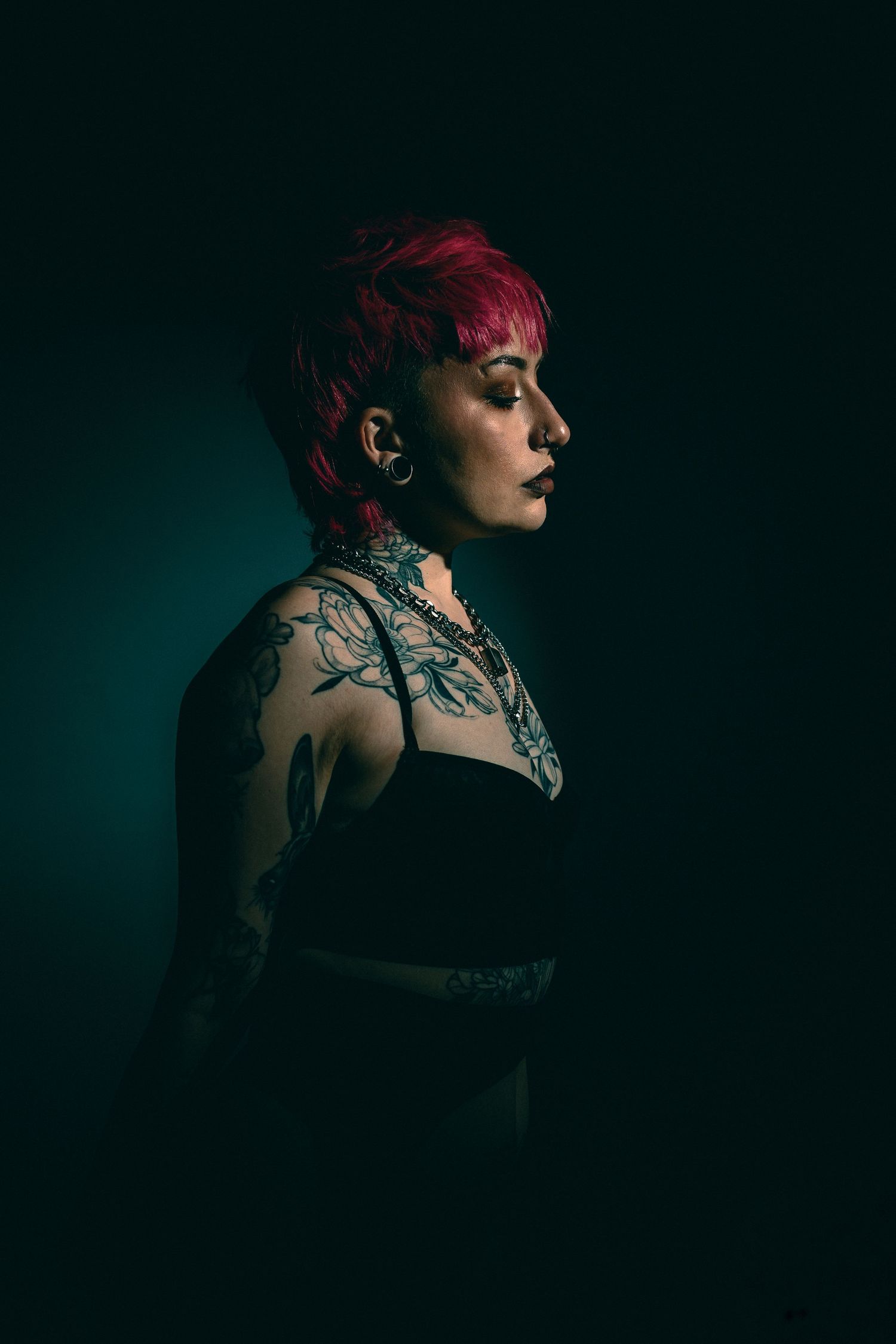 Dramatic low-key portrait series showing tattoos and dark aesthetic styling.