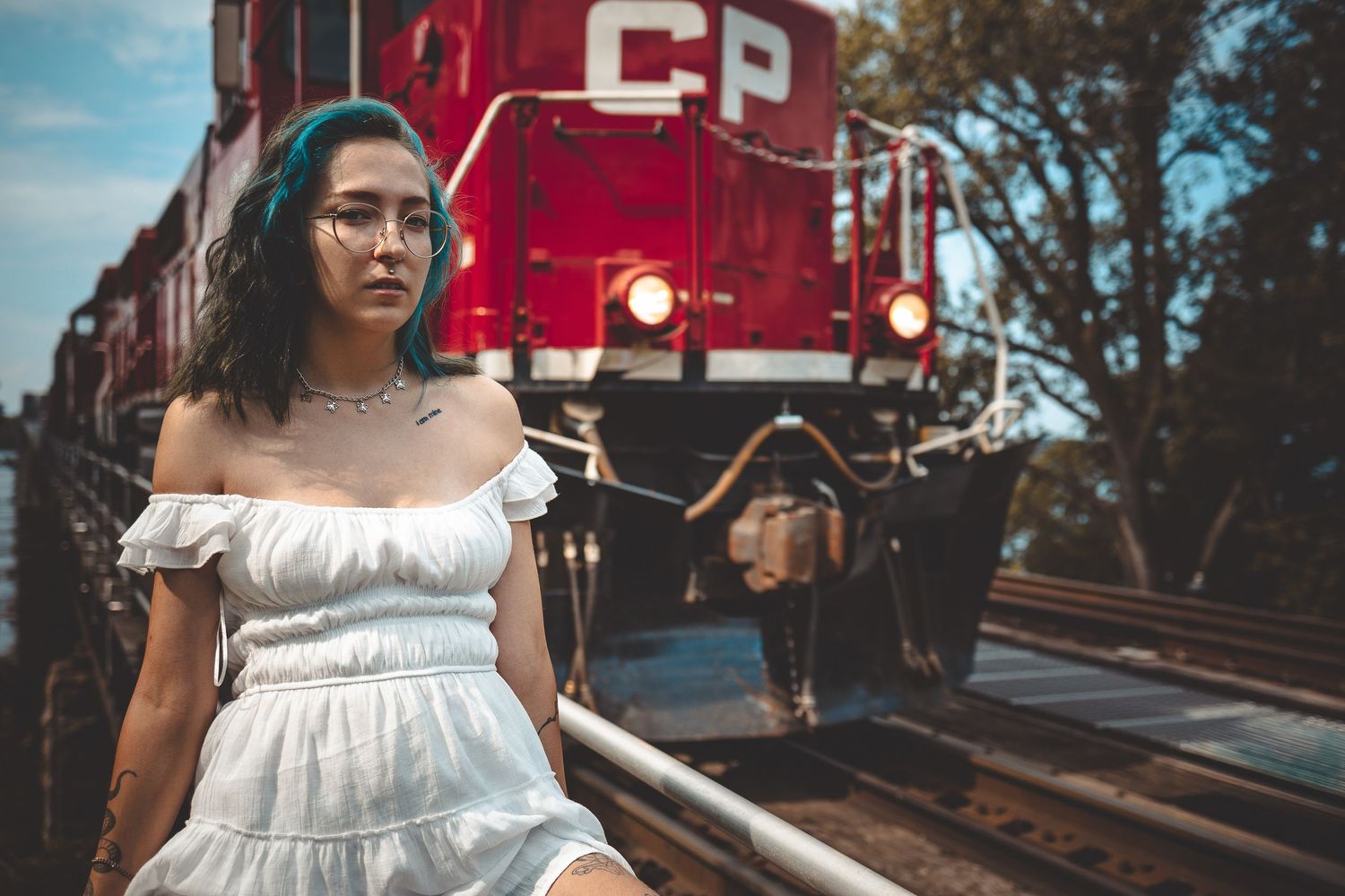 Fashion portraits with vintage red train car backdrop creating nostalgic railway atmosphere.