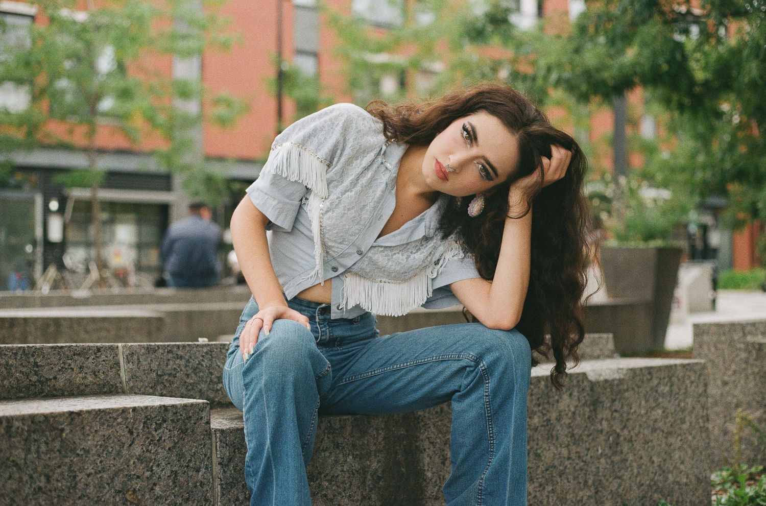 Lifestyle photography session on concrete steps with urban architecture in background.
