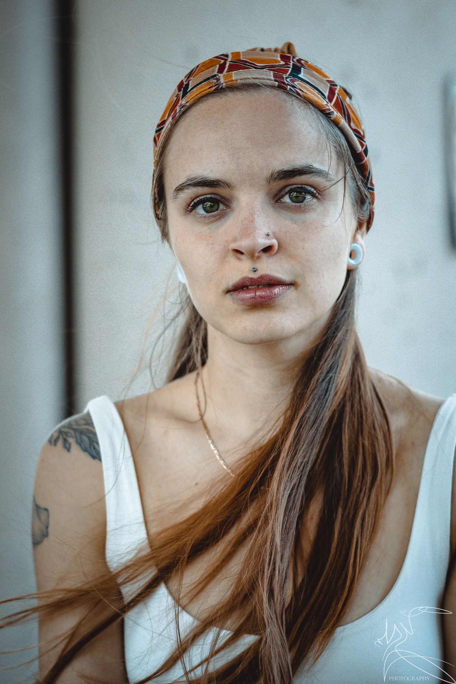 Close-up portrait series with soft lighting and vintage-inspired headwear.