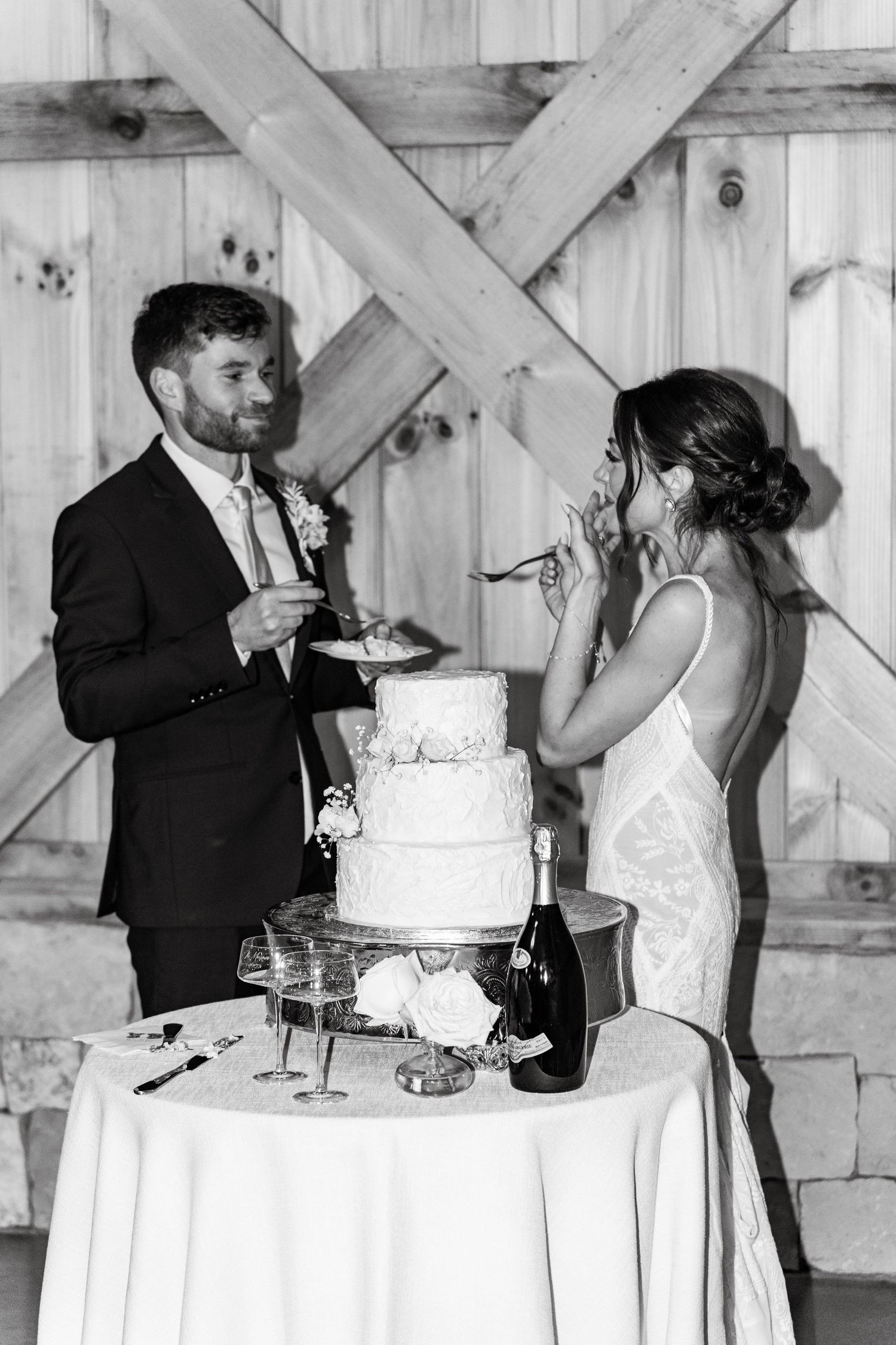 bride and groom cutting cake at The Barn on New River