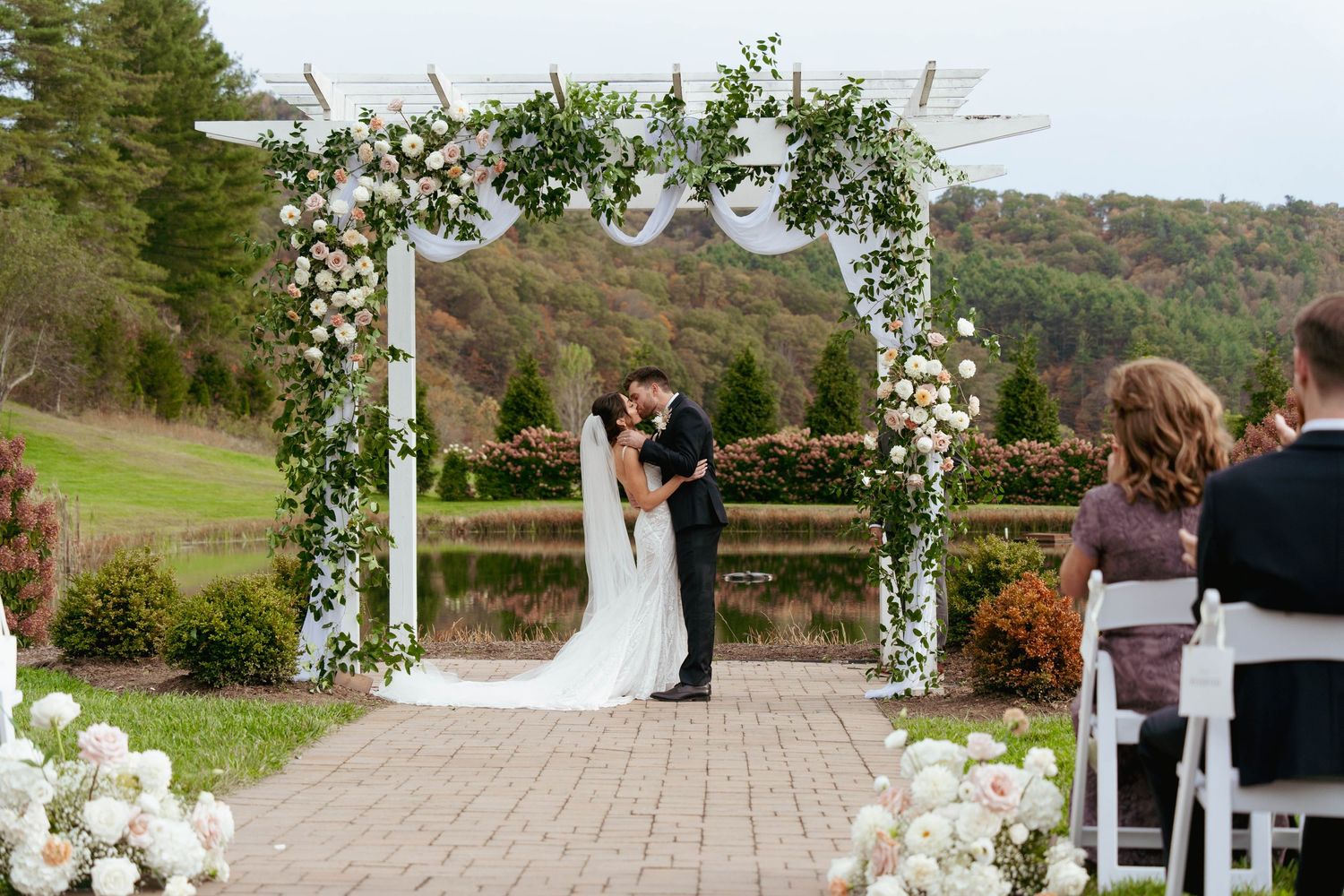 bride and groom first kiss at The Barn on New River