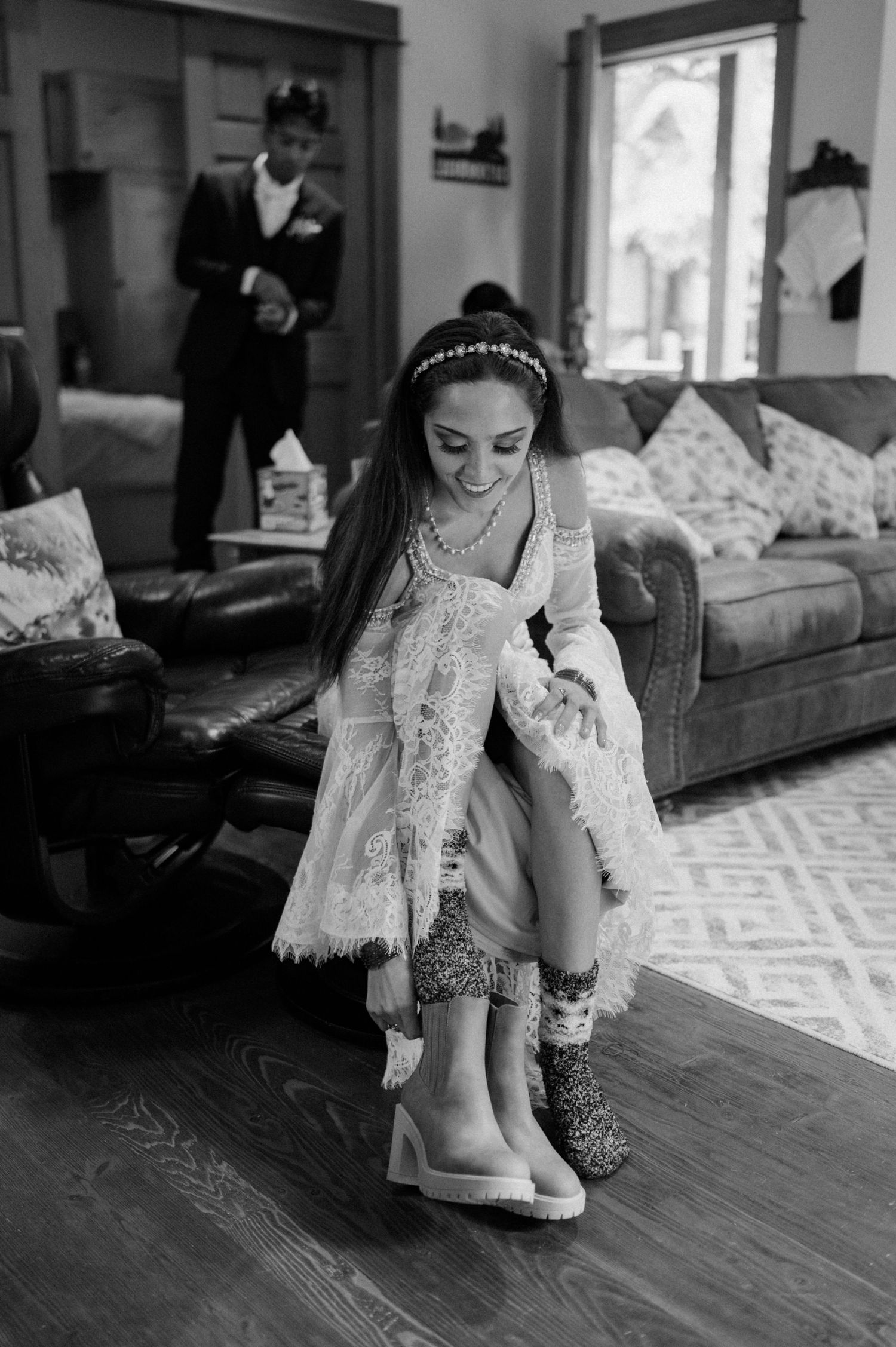 Black and white photo series showing someone putting on white boots while wearing a formal dress.