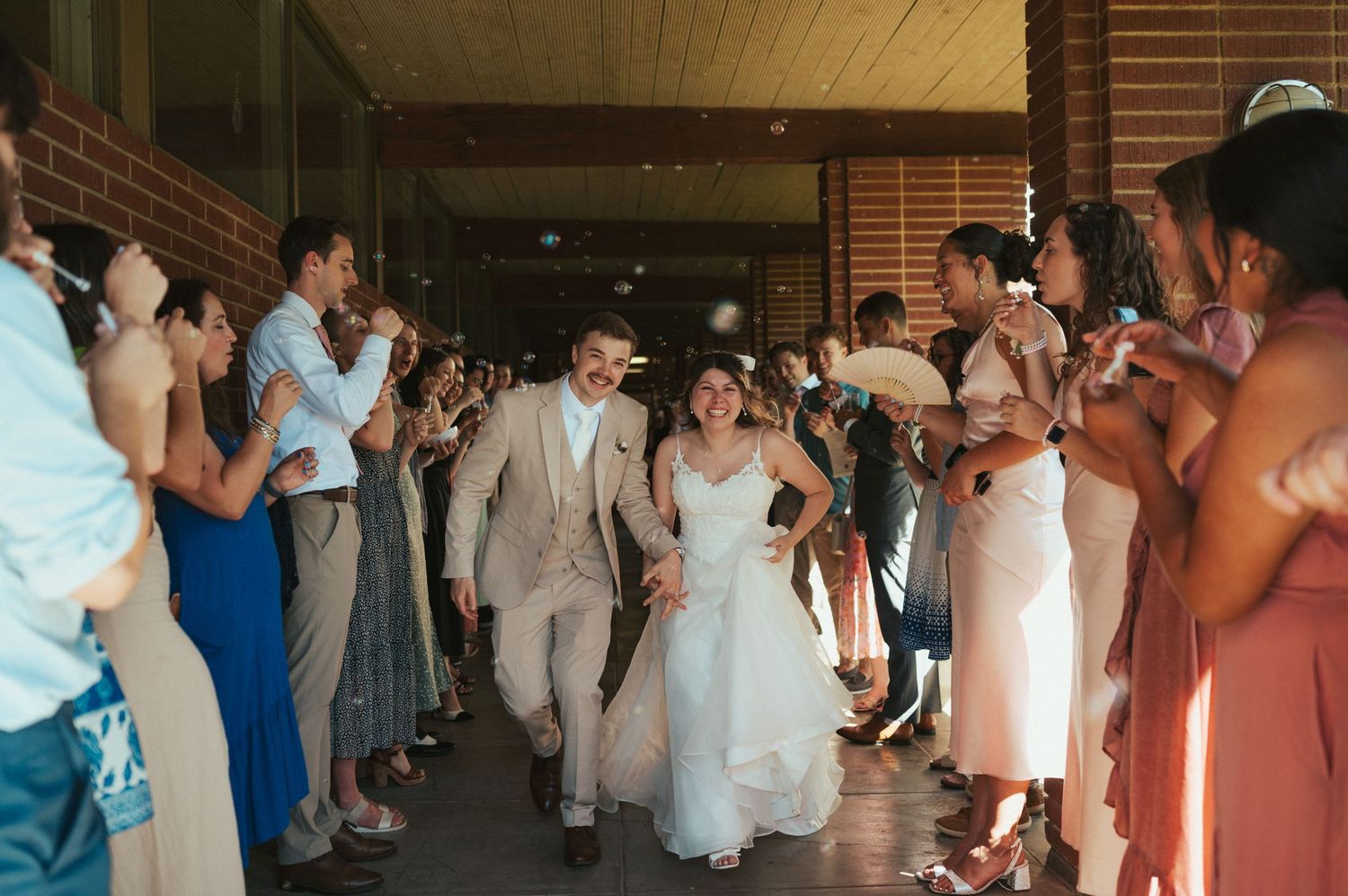 Wedding party dances in a line formation during a reception celebration.