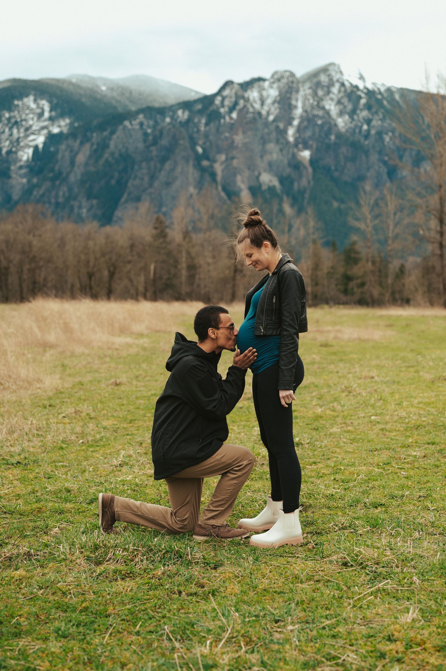 A romantic mountain proposal captured in sequence showing someone kneeling in a scenic field with mountains in background.