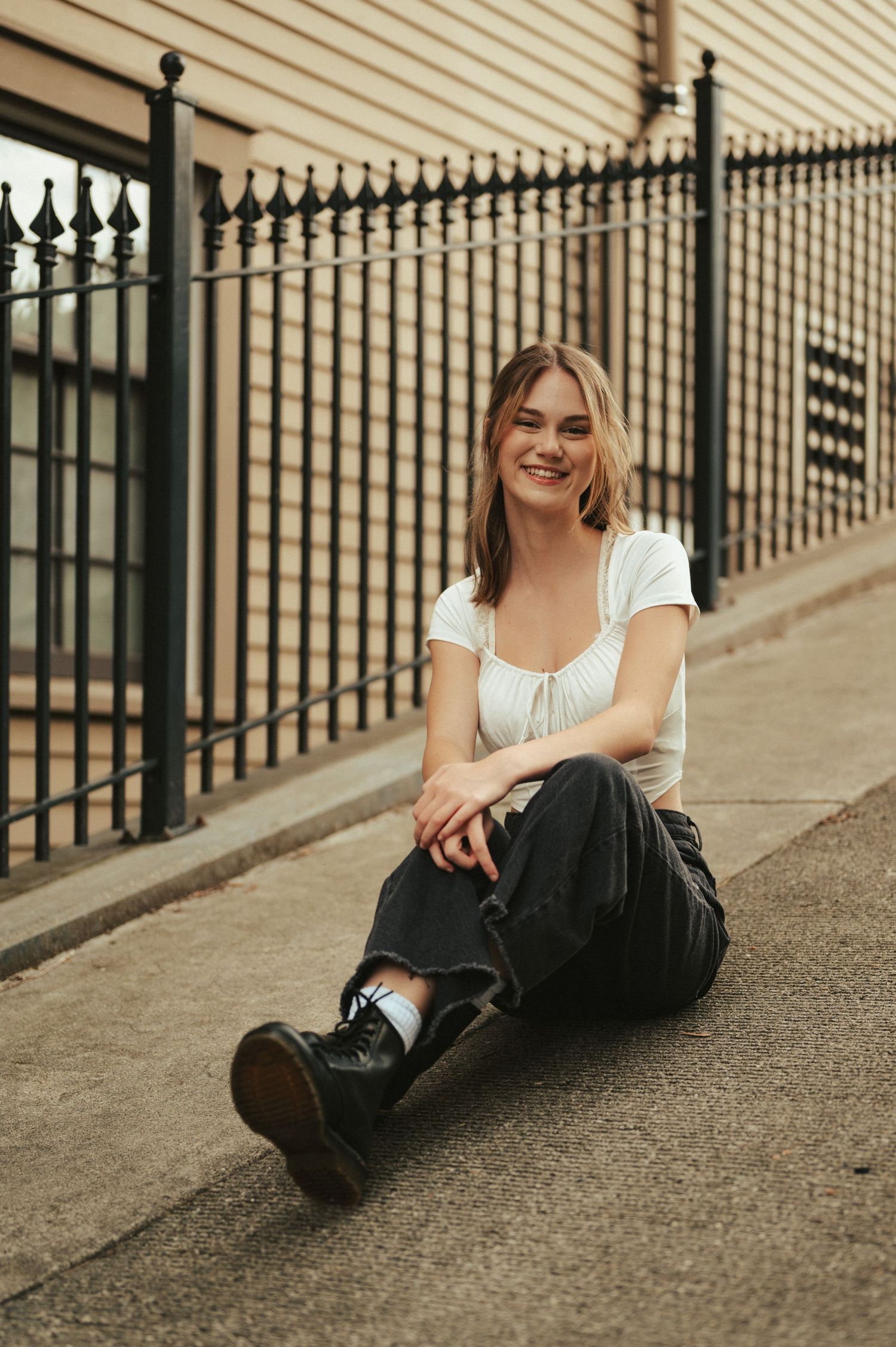 A candid moment of joy captured while sitting by an iron fence.