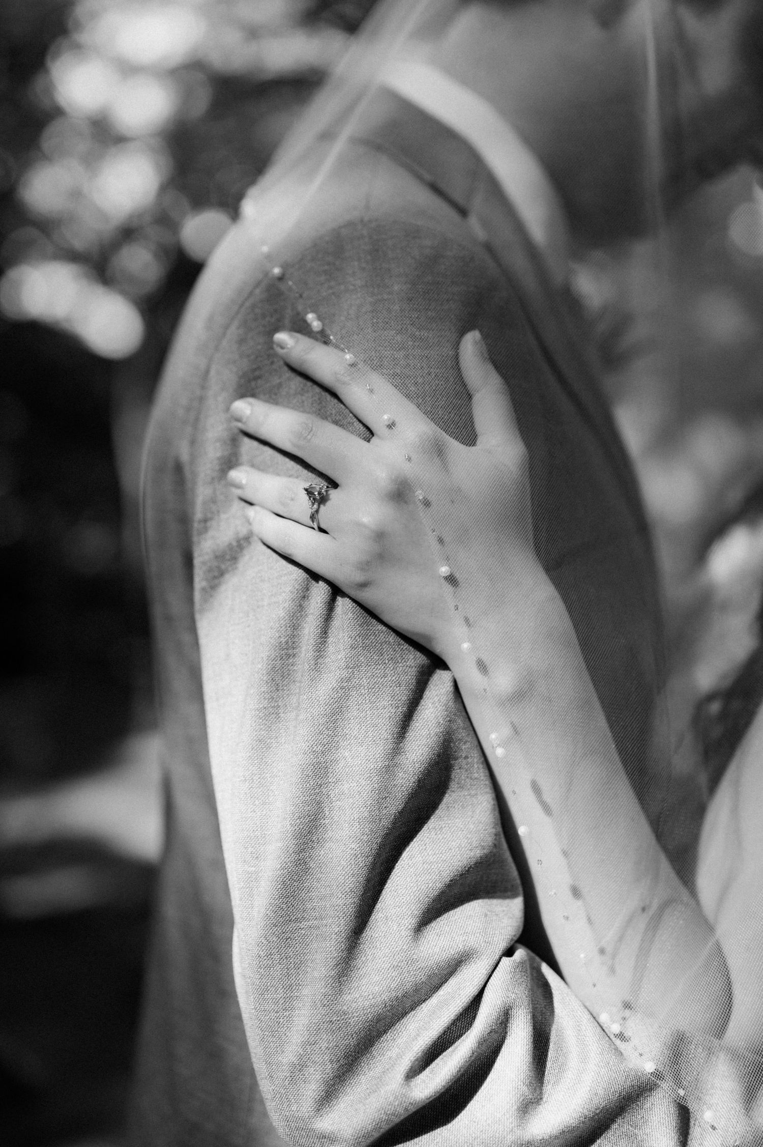 A black and white close-up series showing hands gently touching a sweater.
