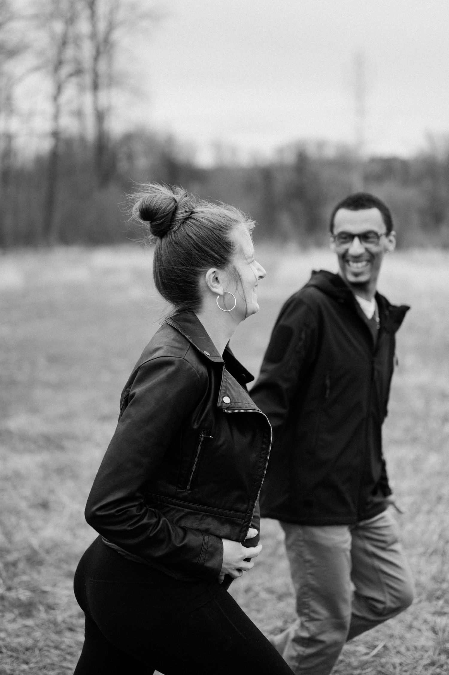 A black and white series showing a joyful reaction to a surprise in an outdoor field.