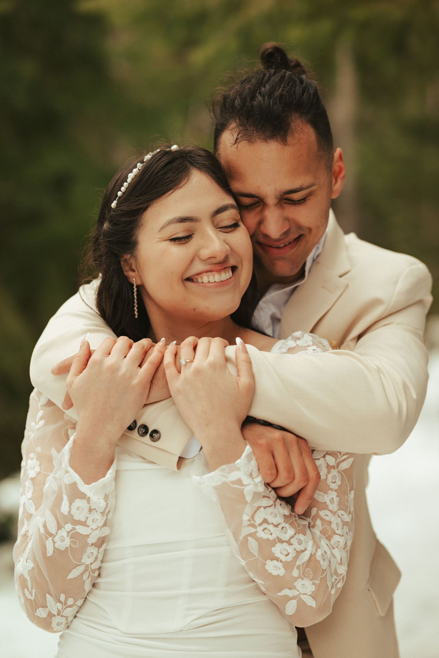 Joyful intimate moment between couple in white wedding attire.