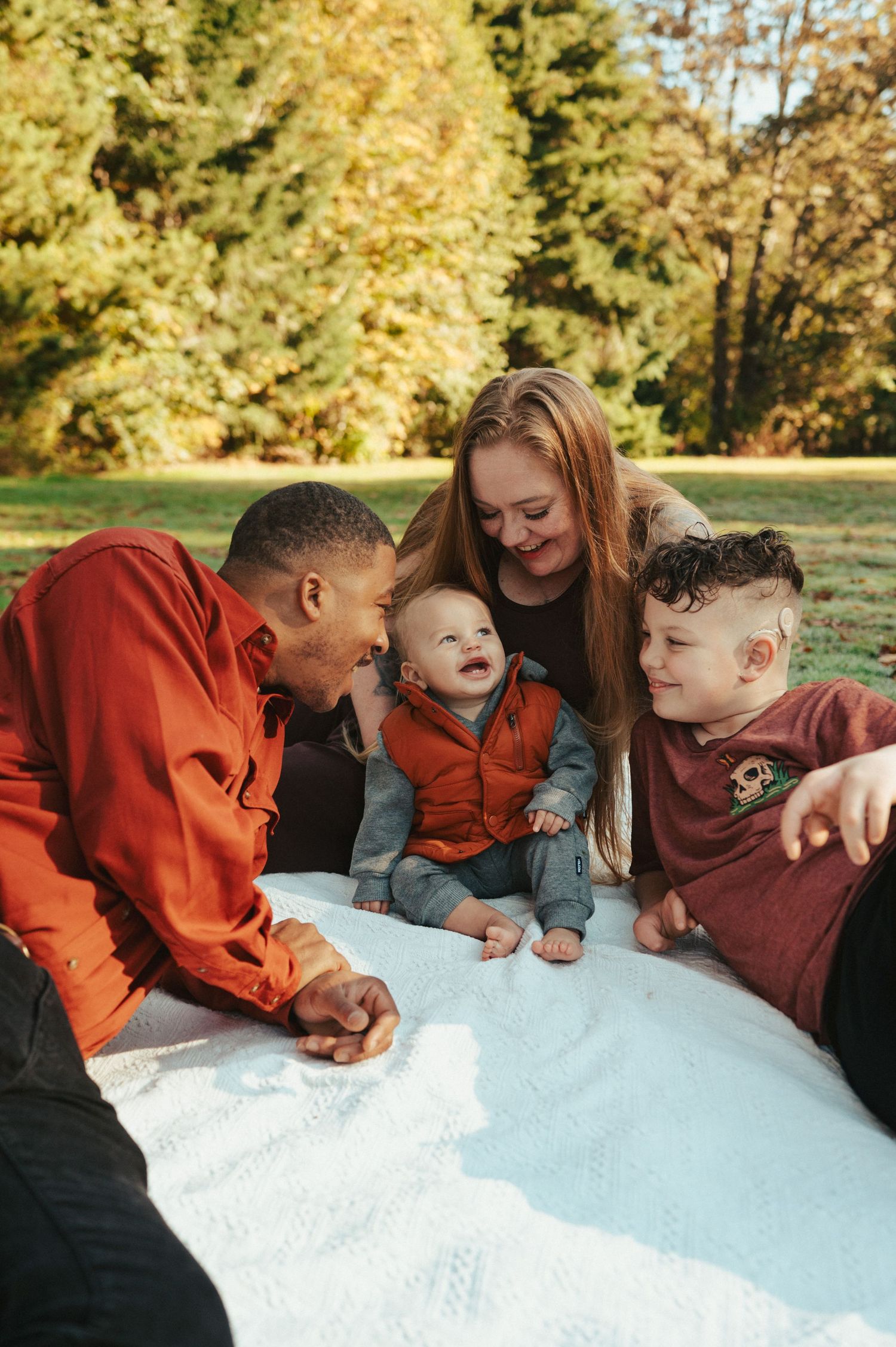 Group gathered around looking at something together in warm autumn lighting.