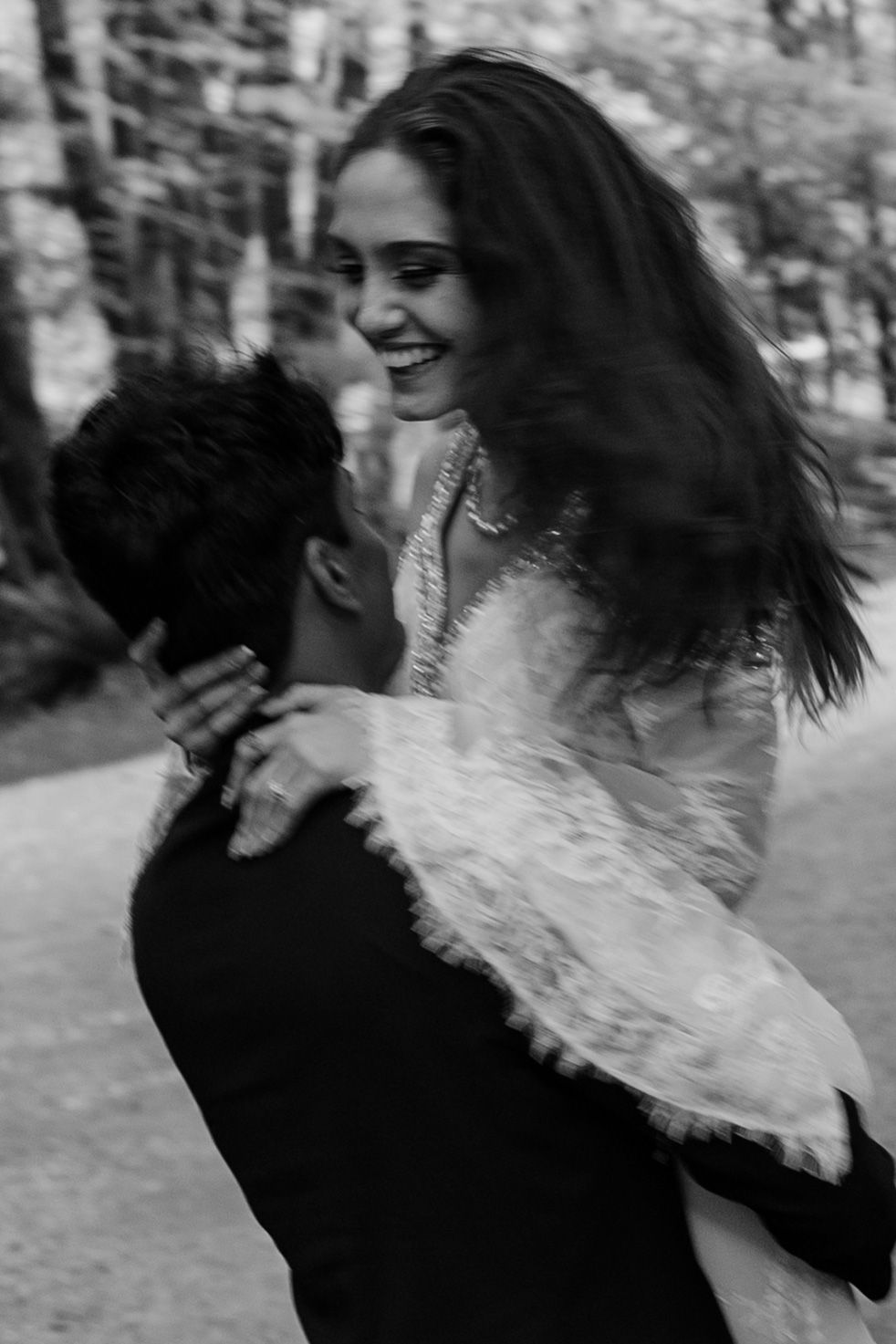 A joyful moment captured in black and white as a couple dances during their wedding.