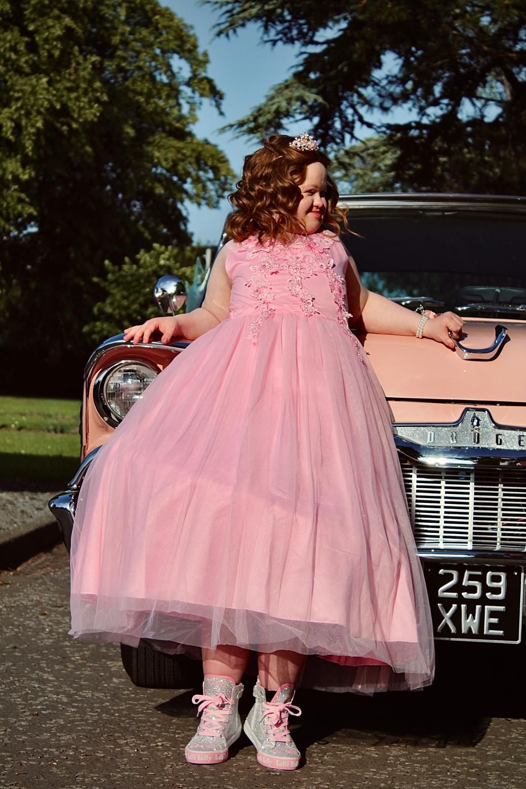Prom photograph of young girl in prink dress with a matching  60's style car, taken in Zetland Park, Grangemouth.