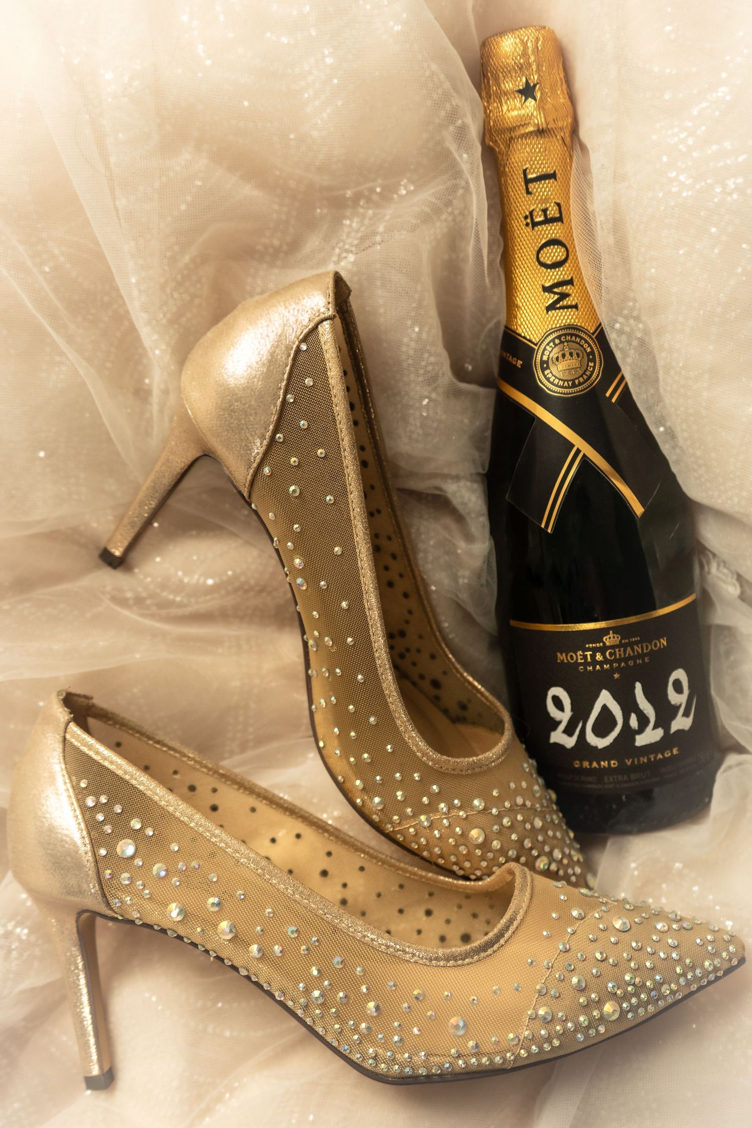 detail photograph of bride's wedding shoes and bottle of Champagne!