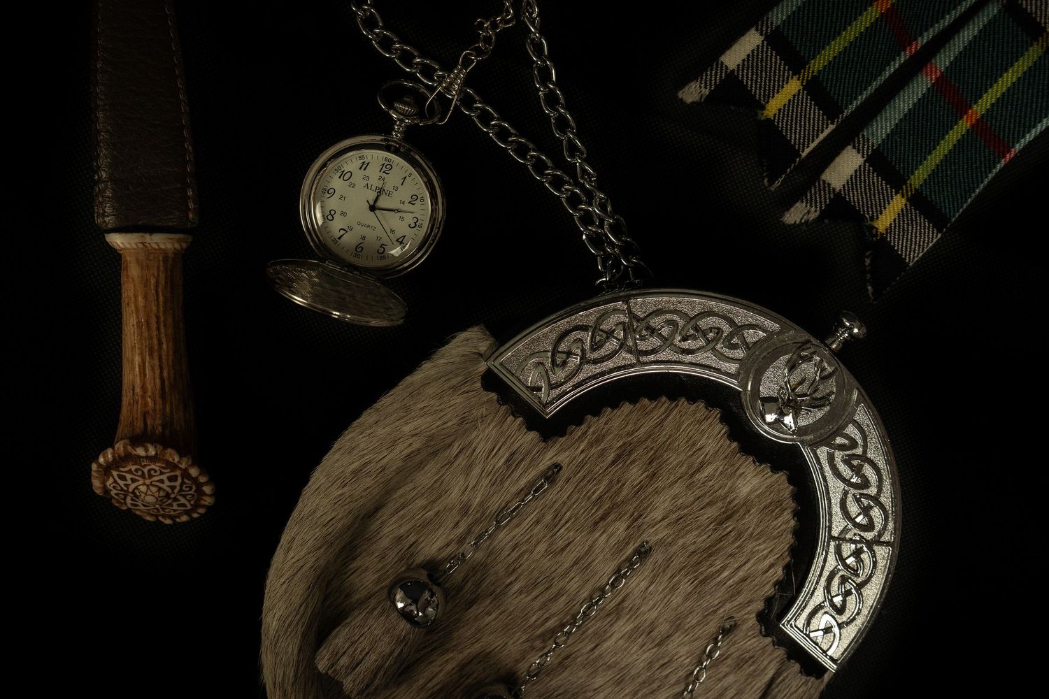 Detail photograph of sporran, flashes, stopwatch and Sgian-dubh