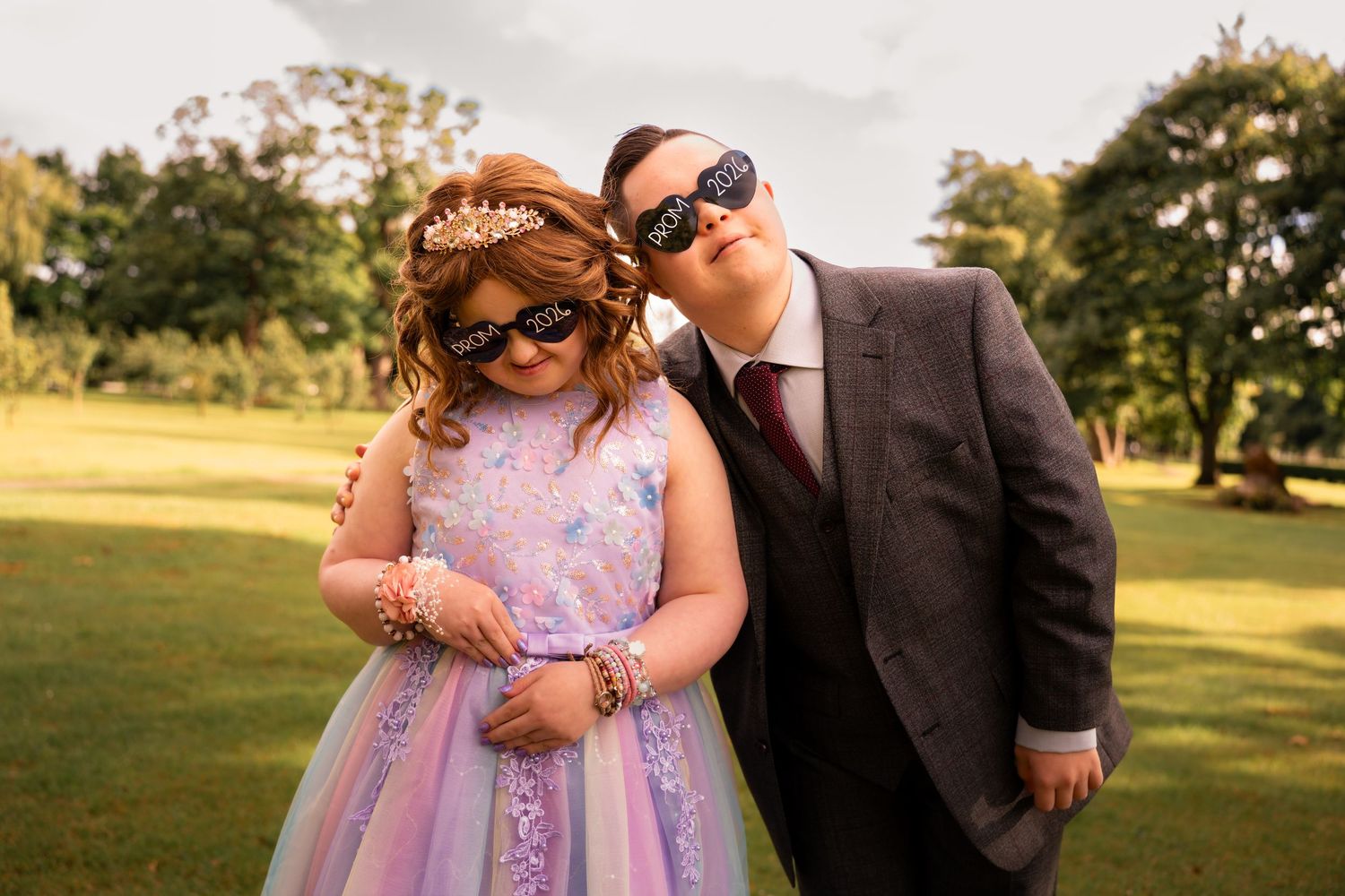 Prom photography Grangemouth 2026 of two friends at Zetland Park, one in pink and purple dress and one in grey suit