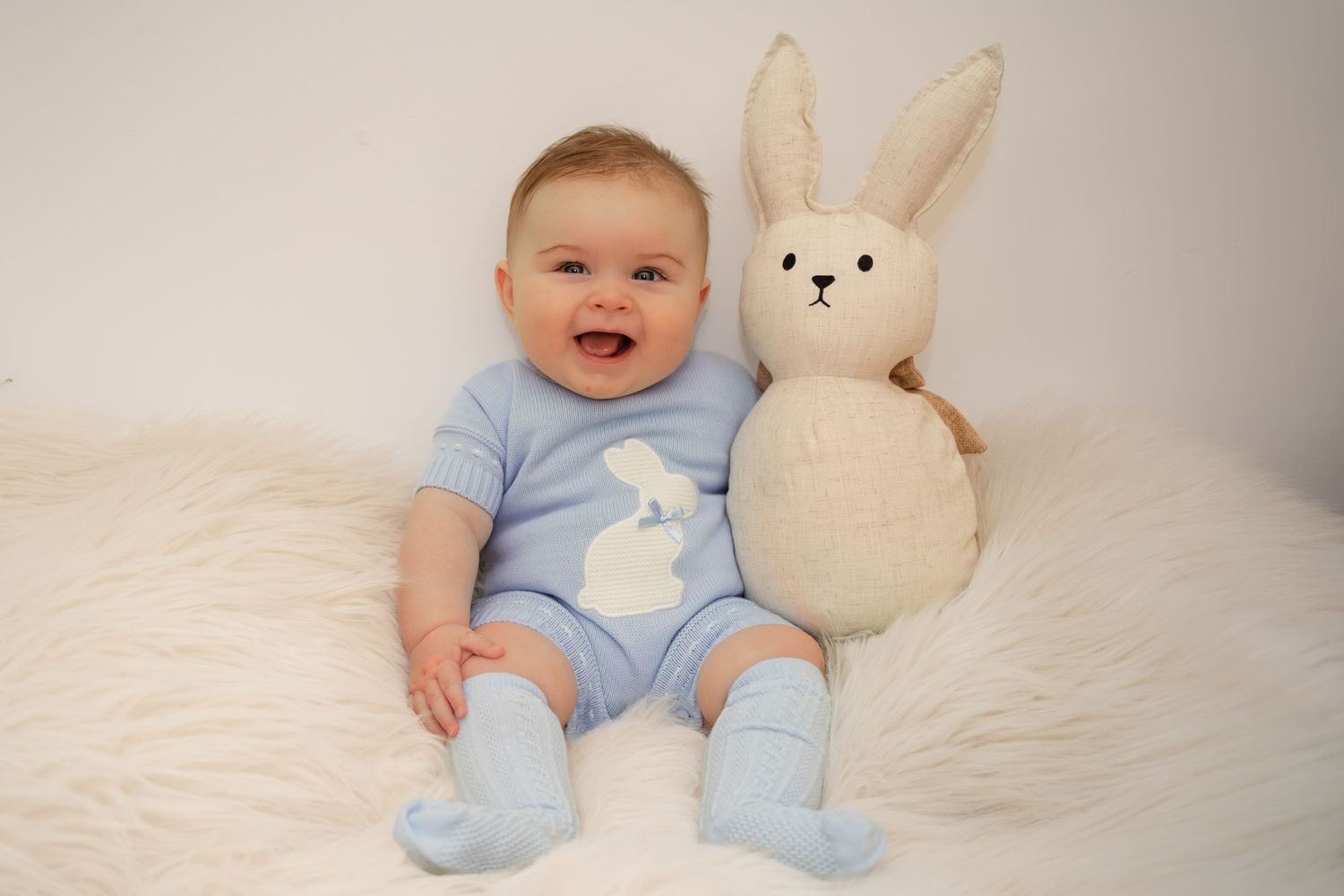 Home studio baby photography session with bunny themed setup and styling
